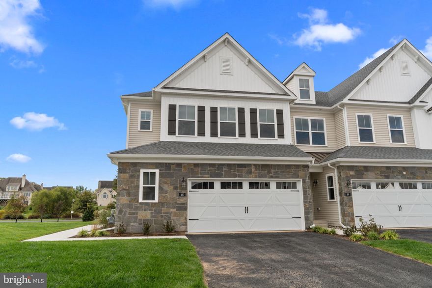 With views of the stunning Spring Mill Golf Course, this brand-new end-unit townhome offers one of the best settings in the community, combining luxury, comfort, and convenience in the heart of historic Bucks County.  Step into a spacious living room with vaulted ceilings, a cozy fireplace, and sliding glass doors leading to a maintenance-free deck — perfect for relaxing or entertaining. The FIRST-floor primary suite impresses with its own fireplace, walk-in closets, and a beautifully designed ensuite bathroom featuring double vanities, quartz counters, gold accents, and a large glass-enclosed shower.  The gourmet kitchen is a showstopper, complete with white shaker cabinetry, quartz countertops, a pasta pot filler, and double ovens, ideal for the home chef. Additional highlights include hardwood floors throughout most of the first floor, first-floor laundry, and a 2-car garage.  Upstairs, you’ll find a loft great for cozy nights, two additional spacious bedrooms, a full bath, and plenty of walk-in closet space. The unfinished lower level provides excellent storage.  Located in the top-rated Council Rock School District, this community offers a rare blend of natural beauty and modern convenience. Enjoy proximity to Tyler State Park, Core Creek Park, and the charming towns of Newtown, New Hope, Doylestown, and Philadelphia.