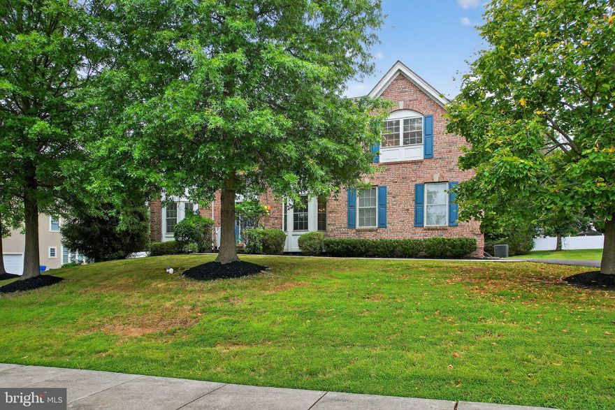 Welcome to this classic Colonial in the sought-after Deerbrook neighborhood of Lower Makefield Township—a small, welcoming enclave of single-family homes. With 4 bedrooms, 4 full bathrooms, a study/5th bedroom, and a 2-car side-load garage, this home offers space, versatility, and a layout that suits a variety of needs. Step inside the 2-story foyer, where sunlight pours through the Palladian window and sidelights. Hardwood floors extend through the foyer, staircase, living room, and dining room, creating a warm flow. Decorative columns define the living room, which is accented with crown molding, wainscoting, and a bay window. Across the hall, the dining room also features detailed millwork and its own bay window, providing an inviting setting for gatherings. The kitchen is spacious and functional, with granite countertops, a center island, stainless steel appliances, and recessed lighting. A breakfast nook with sliders opens to the deck, while a sun-filled sunroom just off the kitchen offers additional space for relaxing or casual dining. The 2-story family room stands out with its soaring ceiling, gas fireplace, and tall windows that bring in plenty of natural light. A study/5th bedroom with a closet and bay window is conveniently located on the main level, with a full bathroom nearby—ideal for guests or flexible use. A laundry room with a utility sink and upper cabinets completes the first floor. Upstairs, the primary suite is generous in size, with a coffered ceiling, a sitting area, two walk-in closets, and a full bathroom featuring a double vanity, jetted tub, and separate shower. The second bedroom has its own private bathroom and bay window, while the third and fourth bedrooms share a hall bath—one of them also highlighted by a bay window. The basement is unfinished, providing excellent storage or a blank slate for future finishing. Outside, the deck offers space for outdoor dining or entertaining. Located in the Pennsbury School District, this home is close to the Yardley Public Library, the Lower Makefield Township pool and community center, Charlann Farms, and an array of shopping and dining. With its light-filled rooms, generous layout, and prime location, this home is ready to welcome its next owners.