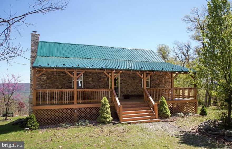An Eagle's View!  An amazing vista awaits you atop this Mountain Top Paradise! Entering this cabin your eyes instantly focus on the site of the Cacapon River Basin, then you'll take notice of the warm pine interior, high vaulted ceilings with exposed beams and sturdy wooden center post. There is a wood burning stove with stone hearth and heavy wood mantel. This is how a country cabin is supposed to feel! 3 bedrooms, 2 full baths, central heat and air.  Well-designed kitchen with island bar and stools. Over 1700 sq. ft. of finished living area.  Utility room and storage / workshop, also a separate outdoor storage shed.  For outdoor enjoyment you'll find two large, covered porches for enjoying those wonderful eastern sunrises and laid-back afternoons, a fire pit for roasting marshmallows and walking trails within the 9.21-acre parcel. There are also mature apple, peach and paw paw trees. Berkeley Springs with its spas, festivals and shops are just a short drive away. Also, as an added bonus there is 2,500 acres of state wilderness land just down the lane. Most furnishings convey making this a ready to enjoy opportunity.  Make your appointment today before this one slips by!