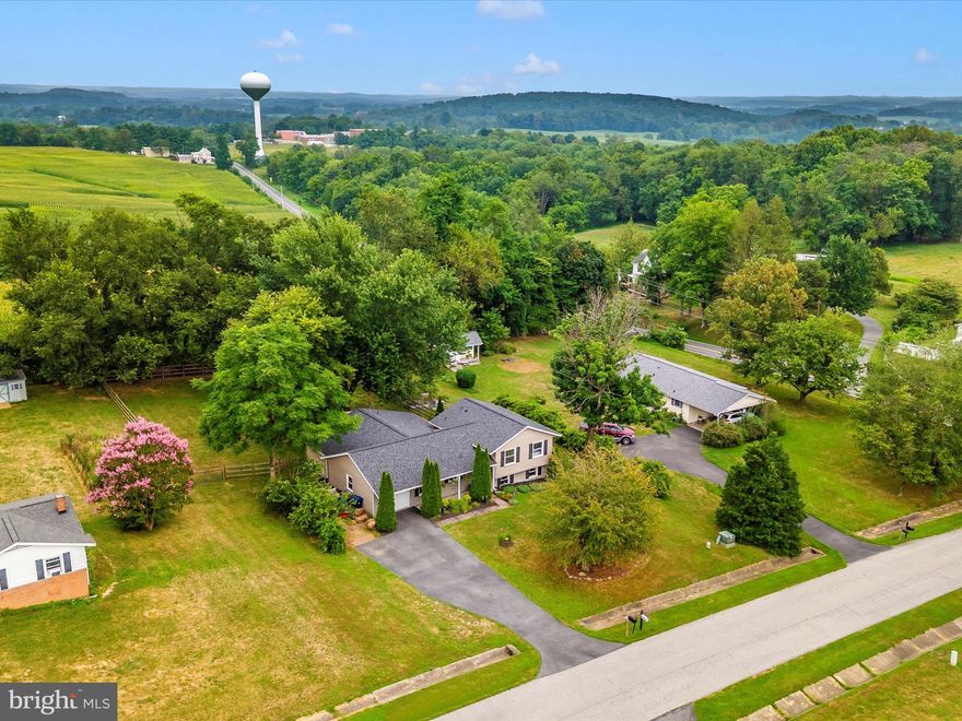 OPEN HOUSES SATURDAY 8/9 10AM-12PM AND SUNDAY 8/10 1PM-3PM. Welcome Home to Libertytown! Tucked away on a peaceful street just off Daysville Road, this charming home offers the perfect balance of tranquility and convenience—without any HOA restrictions. Boasting more space than it appears, this beautifully appointed property sits on a flat .55-acre lot, featuring a fenced-in yard and a stunning garden. Whether you’re an avid gardener or want a safe haven for your furry friends, this space is ready for your personal touch. Step onto the covered front porch and take in the lush, landscaped front yard. The oversized one-car garage provides plenty of room for both vehicles and storage. Inside, you'll be greeted by a welcoming foyer with gleaming hardwood floors. To your left, the kitchen shines with stainless steel appliances, granite countertops, white cabinetry, and a large pantry. The adjacent dining area offers a perfect spot for family meals. The spacious living room is perfect for gathering and unwinding, while the sunroom on the main level brings in natural light through large windows and offers a serene space for relaxation. Also on this floor, you'll find a primary bedroom featuring a walk-in closet and an en-suite bath with tiled flooring, granite counters, and a walk-in shower. Upstairs, there are three generously sized bedrooms and a beautifully updated full bathroom. The lower level features a second living room, laundry area, and a huge bonus room that could easily be transformed into a fifth bedroom or home office. Outside, the large deck overlooks the fenced backyard—ideal for grilling, entertaining, or enjoying Maryland crabs with friends and family. This home offers an exceptional level of privacy, providing a peaceful retreat while still being just minutes away from major commuter routes like 75, 26, 31, and 70. Recent upgrades include: New Siding (2025), New Gutters (2025), New Fascia (2025), New Microwave (2025), Dishwasher (2025), Garbage Disposal (2025), New Stove (2023), New Garage Door Opener (2023), New Water Heater (2022), Roof (2021), and so much more! Located in a prime Frederick County location, you’re close enough to major highways to make commuting a breeze but far enough to enjoy the beauty of Frederick County’s countryside. Don't miss the opportunity to call this home—schedule your tour today before it's gone!