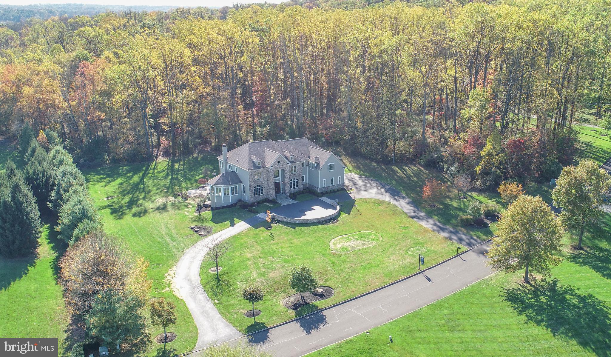Move right into this magnificent 6 bedroom, and 7.5 bathroom luxury estate property in the prestigious community of Jericho Mountain East, one of Bucks County's most sought after addresses. Located in the award winning Council Rock School District and is literally a short walk to Jericho National Golf Course! This spectacular one of kind home sits majestically on 3.5 acres. A circular driveway leads to the court yard parking area in front of the main entrance. Follow the blue flagstone walkway, through the large mahogany front doors and into the marble foyer complete with detailed moldings and a magnificent custom wrought iron railing. The foyer is flanked on the right by the formal dining room with tray ceilings and to the left by the custom cherry wood library with wet bar. Perhaps the most enjoyed area of any home is the kitchen space. Here at 3 Great Hills Road, there is no exception. The kitchen is light drenched with beautiful granite countertops and offers a commercial Viking range & ovens, solid stone hood surround, built in microwave, subzero fridge/freezer, oversized center island, long breakfast bar, built-in desk area & large pantry. The dimensions of the breakfast room are quite generous and will accommodate a spacious table and chairs. The kitchen opens to the great room with hardwood flooring and floor to ceiling stone fireplace. There is also a door leading to the brand new maintenance free deck and another that opens to the light drenched sun room. A fantastic feature included with this home is a first floor bedroom suite with full bathroom. This is one of six bedrooms offered in this home. Upstairs is the opulent owner's suite with a gorgeous main entrance and has door to a private deck, deep tray ceilings, massive walk-in closet, 3 - sided propane fireplace, opulent marble bathroom with duel vanities, enormous spa-style shower and soaking tub. There are 4 additional bedrooms upstairs, each en-suite, including a mini-suite with sitting room and deck overlooking the rear yard. Below is the beautifully finished walkout lower level with so many areas to play and entertain including the home theater room and built -in window seat area. There is also a full bathroom that completes the lower level. Other home features include state of the art heating/air conditioning, sound and security systems; with each room having its own zone, generator, instant hot water available throughout the house, central vacuum, radiant heat in every room, whole house audio system, and home security visible from every room. Outside is just breathtaking with wonderful views and plenty of space to enjoy. Easy commutes to NYC, Philadelphia, Routes 95 & 202 and the Princeton Route 1 corridor. A must see estate property!
