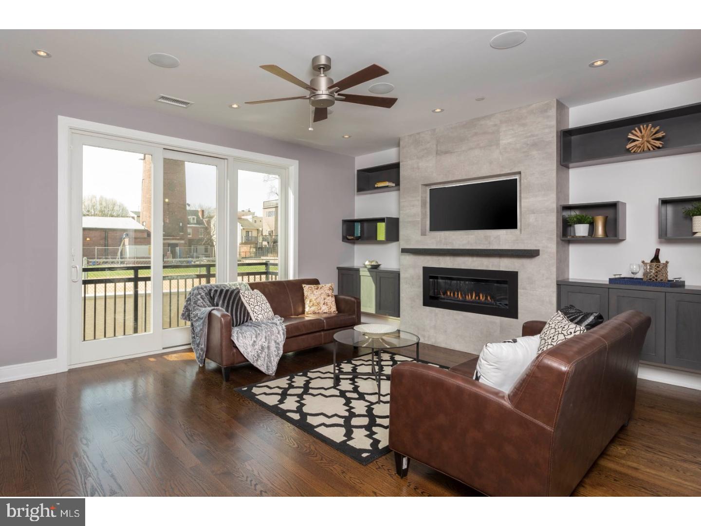 One unit left! This 4,500 sq. ft. LUXURY home is found at Shot Tower Estates; a 9 unit, new construction GATED development which offers 4 Bedrooms, 3 Full Baths, 2 Powder Rooms, an ELEVATOR and 2 CAR GARAGE parking in Queen Village. Select gorgeous finishes throughout the 19' wide home to create a custom feel. The first floor offers a stunning floating steel staircase, 2 car Garage and Bedroom; ideal as a home office, located off the front entry with a powder room conveniently concealed. Downstairs, the finished Basement is the ideal Guest Suite, In-Law suite, Media room or Gym with high ceilings, a full Bathroom and custom built wet bar with wine frig. Upstairs, the open floor plan was designed with entertaining in mind with a surround sound system, a Living Room with a stunning gas fireplace as the focal point with a tile surround and stone mantle. The professionally designed Chef's Kitchen showcases custom-built cabinetry, an island with bar seating, stone counters, a Wolf/Sub Zero appliance suite with cooktop, stainless floating hood, wall oven, microwave and features cove & under cabinet accent lighting and backsplash. Step outside to a rear deck; perfect for your grill and outdoor dining. The Dining area sits alongside the Kitchen as well as a Powder room; ideal for hosting dinner parties! The 3rd Floor features 2 large Bedrooms, a full Bath and Laundry room with sink, folding counter and upper cabinetry. 4th floor Master Suite is pure luxury with a gas fireplace in the Bedroom area, THREE walk-in closets and a Spa-like Master Bath with an oversized shower (multiple shower heads), a freestanding soaking tub, heated floors, and a custom double vanity. The pilot house offers a wet bar for serving cocktails while enjoying Fireworks and Sunsets seen from the huge roof deck with outdoor audio and 360 degree views of the city! Whole House audio, 2 alarm key pads, video intercom system and LED lighting throughout are just some of the intricate smart home features that are offered. Oak, stained in place hardwood floors, ample closet space and huge windows for natural lighting add to this custom mini mansion in the heart of Queen Village. Walking distance from many restaurants, bars, cafes, Shot Tower playground/Rec Center and the Delaware River Waterfront. 10 yr tax abatement pending. If you're looking for a QUALITY built home, once inside, you'll discover the extraordinary craftsmanship. Delivery Fall 2017