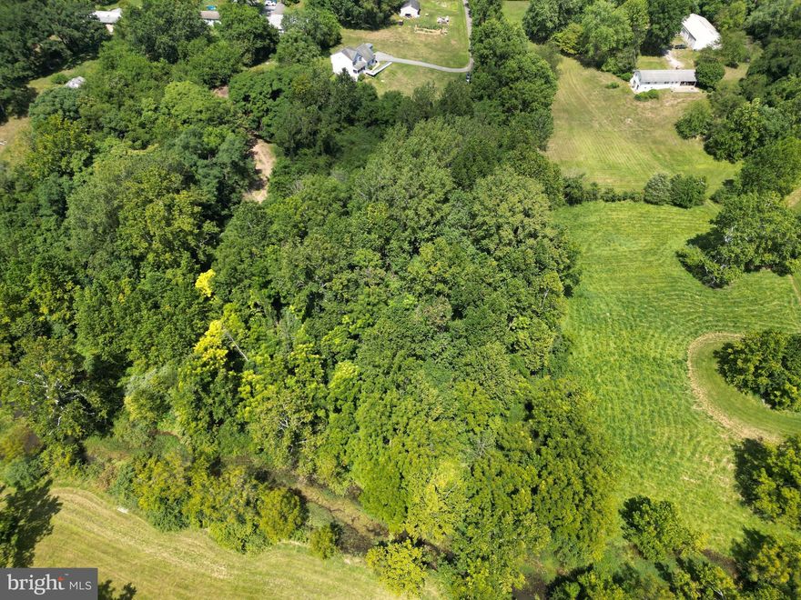 Welcome to an extraordinary opportunity in the heart of the city, where a generous building lot invites you to craft your urban oasis. This expansive property not only offers ample space for your dream home but also boasts a unique connection to nature, as it adjoins the picturesque Flowing Springs Run for approximately 250 feet.

Imagine waking up to the soothing sounds of a babbling stream, your home nestled in the midst of the city yet cocooned in the embrace of nature. With mature timber scattered throughout, you'll enjoy the luxury of shaded yards and the allure of a tranquil setting right at your doorstep.

For those who seek entertainment and excitement, this property's location is a true gem. Situated in close proximity to the race track and casino, you'll have the convenience of experiencing the thrill of the track and the allure of gaming just a stone's throw away.

Adding to the character of the property, remnants of an old barn stand as a testament to the history of the land, blending the past with the potential for your future. A well has already been drilled, paving the way for the construction of your envisioned home.

The convenience continues with a public sewer hookup already available on the property, eliminating the need for complicated sewage solutions. Additionally, electric infrastructure is already on-site, streamlining the building process and ensuring that you're well-equipped for modern living.

Whether you envision a contemporary urban retreat, a fusion of city living and natural splendor, or a haven where convenience meets tranquility, this large building lot offers it all. Seize the chance to create a haven that perfectly embodies your vision, right in the heart of the city's pulse.

Embrace the harmonious balance of urban life and natural beauty, and make this property your canvas for the lifestyle you've always dreamed of. Act now and embark on a journey of transforming this extraordinary piece of land into your own urban sanctuary.