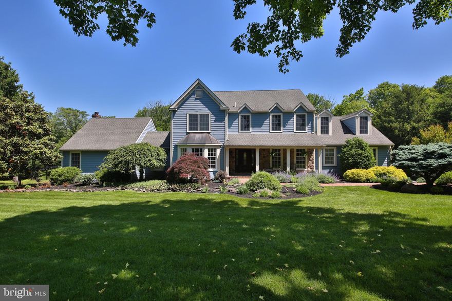 Your long wait for your ideal home is over! This fabulous John Arrow custom-built, stone front, 5 bedroom, 3 and one half bath Colonial style home is something unique and very special. This quality-built home offers TWO full, primary bedroom suites with one on the main floor for those wanting one level living and a peaceful retreat. Situated in the much sought after Pebble Hill setting of Doylestown Township, just a short distance to the Borough of Doylestown, it lends a feeling of being in the far out reaches of the Bucks County countryside. This expansive over 1.5 acre setting will captivate your imagination. Beautifully landscaped, everywhere you look…from the babbling waterfall fish pond off the first floor primary bedroom, to the view of the inground pool/spa from the rear deck, and from under the towering trees to the expanse of the rear of the property. Take your pick, choose the main floor bedroom suite with vaulted ceiling, rustic wood beams and fieldstone fireplace with full bath including a stand alone tub, tiled shower overlooking the pond with a private deck to enjoy morning coffee or an evening glass of wine or choose the traditional 2nd floor primary with ensuite full bath. You enter the home from the bluestone covered front porch into the main floor with Brazilian and cherry inlaid hardwood flooring and elegant wood trims throughout. The gourmet French country styled kitchen, designed by Charles Weiler and once highlighted in “Nouveau” magazine features custom-made cabinetry, granite & marble top, extended island with seating for six, ‘Wolf’ 6-burner commercial range with griddle, copper sinks, tiled backsplash and an exquisite chandelier in addition to the recessed lighting. The first floor is also highlighted by the spaciously sized living spaces: Dining room, Living room with bay window flowing into the Family room with brick fireplace and built-in cases. The 6th Bedroom/office, with its own  separated access, is perfect as an au-pair, guest suite, or office and offers a large picture window seat with a full overlook view of the enticing outdoors. The finished basement with bar provides for additional entertainment space. There is not one but two rear decks that can be accessed either from the main floor bedroom suite or Kitchen with quiet, private views of the pool area and picturesque backyard. The outdoor shed with an interior wood stove can serve as a cozy winter getaway. These unmatched outdoor spaces will be your genteel oasis for entertaining and relaxation. Best of all, the structure and mechanicals of this home are worry free: improvements include Andersen windows, 50-yr architectural roof, hardie-plank siding, newer 3- zone heater, hot water and central air units, newer well pump and water tank, newer Brazilian Ipe wood deck and an inground saltwater pool which has been replastered with tile and has a newer heater. Enjoy the additional assurance of security with whole house generator. What more can you ask for to live the luxurious lifestyle you want and deserve. This magnificent home will provide you with the sense of a private, restorative retreat yet it is just a few minutes from all that Doylestown Borough has to offer. This is it! Don’t delay make your appointment today!