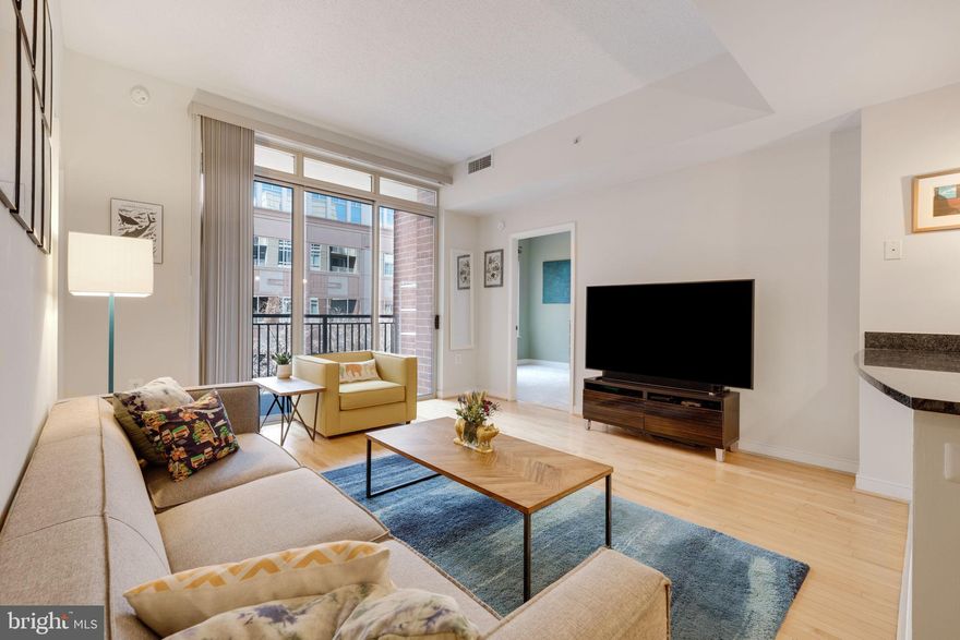 *Rarely Available!* This immaculately cared for two bedroom/one bathroom condo in The Hawthorn Condominium  is a  truly special find!  With over 1,000 square feet of living space, 9'+ ceilings, a spacious balcony overlooking the community courtyard (green views in the spring and summer!), an underground parking space, and immediate proximity to all that Ballston has to offer, this home is the perfect blend of function and form.  Hardwood floors span the dining area, kitchen, living room, and entry foyer - a unique feature of this versatile layout!  Brand new carpeting (2025) adds warmth and comfort to both bedrooms.  The gourmet kitchen space offers 42" solid maple cabinets with a built-in pantry, granite countertops, stainless steel appliances (new dishwasher!), and opens directly to both the dining space and living room.  The expansive ceiling height and added transom window create an airy feel to the living space and the sliding glass doors offer immediate access to a large covered balcony.  Overlooking the community courtyard, this outdoor seating area is ultra private and benefits from treetop views - all on the quiet side of the building.  Head back inside to find a secondary bedroom with an ample size closet as well as an owner's bedroom with a HUGE walk-in (custom ELFA closet organizer throughout).  The bathroom features a convenient dual entry layout for direct access from the owner's bedroom in addition to the unit hallway as well as a separate walk-in shower and a combination tub/shower.  Monthly condo dues cover both water and natural gas as well as access to all amenities including a well equipped community fitness center, a business center and meeting room, an outdoor courtyard and covered seating area, a fob controlled front lobby with on-site management, and underground garage parking.  Located in the heart of it all, 820 N Pollard St is just blocks from a seemingly endless number of restaurants, coffee shops, gyms, grocery stores, popular Ballston Quarter, and both the Ballston andVirginia Square Metro stops.  Don't miss your chance to own this one-of-a-kind condo!