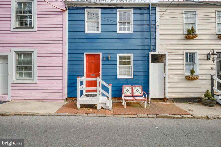 This is your chance to own a property in the heart of the Historic District of Annapolis. Truly walking distance to enjoy numerous unique, locally owned, specialty shops/fine dining/entertainment. Revel in the riches of the area including the Naval Academy, St John's College, MD State House, City Dock, Ego Alley and learn the monumental history.  This quiet street offers this 2 bedroom/ 1 bath townhouse with charm and character. The living room has custom build ins for best use of space, the walls are adorned with Mahogany hardwood detailing, and the wood floors invite you to the comfort of your historic sanctuary. The kitchen has Corian detailed countertops and rich wood cabinetry  with the convenience of an island.  The laundry/utility/storage room is on this level as well.  Your gem is through the french doors to the outdoor private tiered brick terrace  with custom landscaping and wood fencing.  The upper level has two bedrooms with cathedral ceilings, a full bath, and attic access.  Your choice....make this your home/your getaway/an investment property!