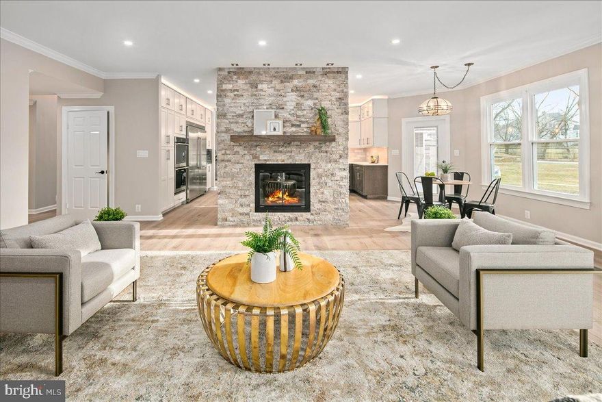 Sophistication mastered! This five-bedroom, four-and-a-half-bath traditional sits on private acreage and conceals a complete top-to-bottom transformation behind its classic three-story façade. Step through the 42-inch solid mahogany entry door and the contrast becomes immediate: every interior surface has been rebuilt around how people actually live today.
Seven-inch wide-plank brushed white oak runs throughout the main level, finished with a matte sealer that disappears into the wood itself. The Great Room rises around a floor-to-ceiling stone fireplace — wood-burning and substantial enough to anchor the entire open floor plan. Where a wall once separated kitchen from dining, there's now a sweeping quartz peninsula, the new social heart of the home. Behind it: an induction cooktop with pot-filler, integrated column refrigeration, custom two-tone hardwood cabinetry with full pull-outs, and a dedicated coffee bar plumbed to its own water line. Upstairs has been re-engineered around the owner's daily routine. The primary suite opens into a hotel-grade wet room finished in seamless stone and marble — deep soaking tub, Schluter shower system, 24-inch rain head, integrated body sprays, thermostatic controls, and radiant heat that carries straight under the shower floor. The custom oak double-sink vanity sits beneath LED-lit anti-fog mirrors, balancing warmth and clean modern lines. Laundry sits on the bedroom level where it belongs, with a second main-floor laundry and mudroom built around cubbies for sports gear and the daily in-and-out. New Andersen windows and bi-directional patio doors, closed-cell spray foam insulation, and a high-tech water softener with automatic filtration. Downstairs, a dedicated media room handles immersive movie nights. Outside is where summer happens. An expansive Trex deck flows off the Great Room toward an inground pool and hot tub framed in sky-blue Travertine coping — ready to swim. A fully renovated pool house with new bath facilities makes weekend entertaining genuinely effortless. All of it set against the kind of mature, private lot Canterwood is known for. Minutes to Tysons, a short drive to the Potomac and Great Falls Park, and falls within the Langley High School pyramid — a fully modern home at one of the area's most established addresses.