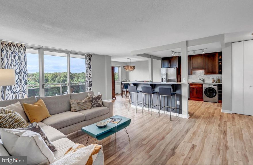 Gorgeous, sun-drenched, 2BR, 2 BA, 8th floor, corner unit with treetop and sunset views plus multiple upgrades in Takoma Overlook! This spacious and beautifully updated condo boasts new flooring (2023) throughout the living, dining, kitchen and bedroom areas, stainless appliances (refrigerator, range, dishwasher and combo washer/dryer replaced in 2023) and has been freshly painted throughout. The generously sized kitchen features marble counter tops, an expansive breakfast bar/counter for added counter space and seating and opens to a separate dining area. The living room leads to a private balcony with breathtaking sunset views - also viewable from the bedrooms, living and dining areas. The unit's multiple closets provide plenty of storage space featuring a walk-in closet in the primary bedroom and a kitchen pantry. Takoma Overlook amenities include an outdoor pool, tennis, tot lot/playground, picnic area, assigned parking, dog park and more. Note: All utilities and amenities are included in the condo fee and all special assessments have been paid in full by the owners.