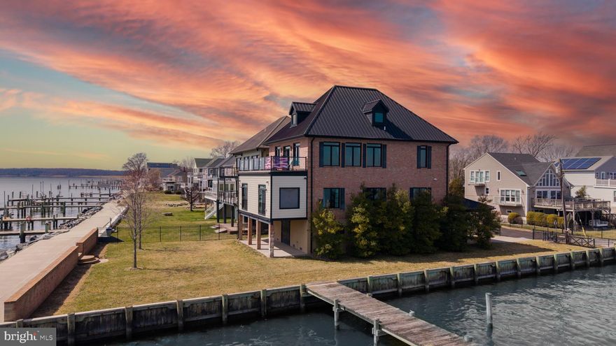 This opulent Chesapeake Bay waterfront estate on Millers Island features unmatched craftsmanship that defines luxury living on the Chesapeake Bay.   Spanning over 3,500 finished square feet and situated on a prime lot with 230 feet of pristine shoreline, this masterpiece offers breathtaking views of the Chesapeake Bay Bridge and the iconic Millers Island lighthouse along with fantastic fishing, birdwatching, and unforgettable sunrises. 

Constructed with resilience and elegance in mind, the home was constructed to meet ocean front property standards with 36 pilings driven 48 feet deep and four feet of added elevation, ensuring long-term stability and peace of mind. All exterior walls and ceilings are spray foam insulated ensuring superior R Factor rating. Durable metal hip roof rated to withstand 125mph winds along with impact resistant wooden windows. Back up, standby Generac generator with ability to power entire home. Elevator for easy access from ground level to each floor of the home. 

 The new bulkhead, riprap, and high wave breaker brick wall offer superior waterfront protection. A 45-foot pier extends your lifestyle directly onto the bay. The solid concrete and stone garage has two automatic doors with room for 4 vehicles. Concrete, gated driveway also has attached carport for 2 vehicles. 

Inside, opulence meets innovation. Soaring cathedral ceilings, exposed beams, and skylights fill the space with natural light. Meticulous solid mahogany woodwork, exposed beams and 9-foot solid mahogany doors offer privacy and sophistication throughout. A wood-burning stone fireplace warms the top-floor living area, thoughtfully designed with an inverted floor plan to maximize water views.

The award winning gourmet kitchen features a tiger-wood trimmed island with hidden pop up flat screen tv, granite countertops, solid brass fixtures and custom cabinetry. Large pantry and cabinet panel front over sized Sub Zero fridge only add to the magnificence of this kitchen.  

This coastal retreat has a primary bedroom with water front views from every window. A spacious walk in closet and a crawford ceiling elevate the ambiance, complete a cozy coffee nook overlooking the water.  En suite tile bath with linen closet and frames glass oversized tile shower.
Guests enjoy their own private nook with a half bath.  Additional bedroom suite  with full tile bath and frames glass shower. Every space is climate controlled via a dual-zone geothermal HVAC system for energy cost savings.

Located on Millers Island, a unique waterfront community within Sparrows Point known for its island vibes and charm. Several restaurants and bars are located on Millers Island including Dock of the Bay, The White Swan and Row Boat Willies dock bar. Marina and boat ramp also on Millers Island. Vibrant community known for its golf carts and embracing the water front lifestyle. Close access to 695 and just minutes from downtown Baltimore. On the water, this home is centrally located on the Bay with many waterfront destinations just a short distance away by boat.

This is a rare opportunity to own a meticulously engineered and designed property that combines timeless craftsmanship with modern luxury in one of the Chesapeake Bay’s most scenic locations.