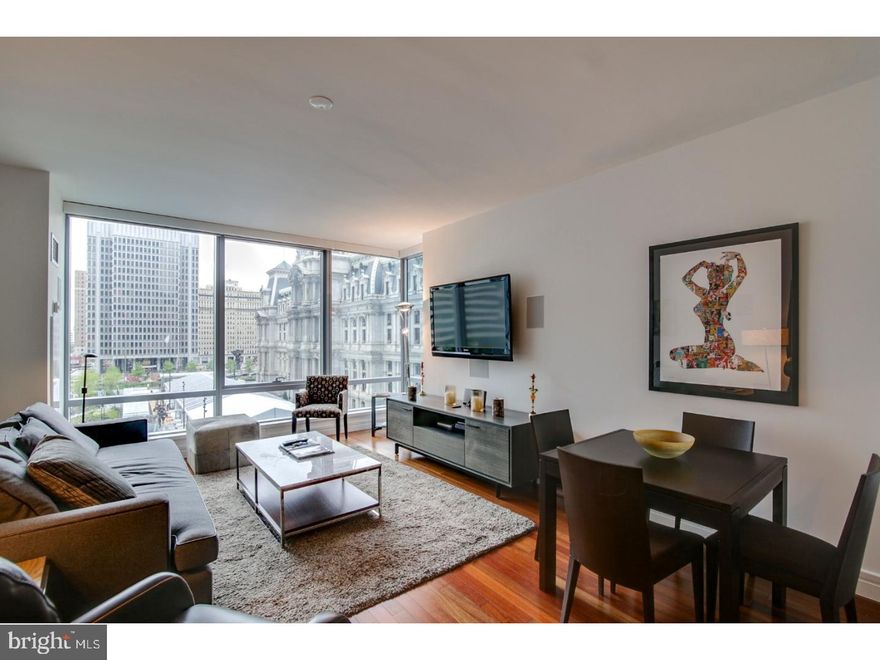 Meticulously maintained and upgraded, this is the largest 1-bedroom layout offered in The Ritz-Carlton Residences.  Walk into tree-top views of Dilworth Park and City Hall with floor-to-ceiling operable windows that fill the space with natural light. On-site valet parking is included!
Brazilian Cherry hardwood floors, custom automated lighting and window shades, a gourmet kitchen with Sefina espresso cabinetry and premium appliances, including a Viking gas range and convection microwave, Sub-Zero refrigerator, and Miele dishwasher. 
The spacious bedroom easily accommodates a king-sized bed and offers three custom closets, all while providing stunning views of City Hall. The luxurious ensuite bath is a true spa-like retreat, adorned with Calacatta Gold marble, a double vanity, an oversized glass-enclosed shower, and a Bain ultra-soaking tub for the ultimate relaxation experience. Uniquely for a 1-bedroom home, there is also a guest powder room—a rare and highly desirable feature—along with a laundry closet equipped with a stackable washer and dryer.
 Enjoy the best of luxury living with access to world-class Ritz-Carlton services and resident-only amenities. These include 24-hour concierge, porter, and valet services; chauffeur service; a state-of-the-art fitness center; an indoor lap pool, hot tub, and locker rooms with showers; and a private yoga room. The resident lounge is perfect for daily use or private events at no additional cost. Additional amenities include a theater room, a newly renovated outdoor terrace with grills, dining areas, fire pits, and lounge seating, an on-site dog park, and a gated garden with direct access to The Ritz-Carlton Hotel.
 Hotel services such as 24-hour room service and catering are also available to residents at an additional cost, ensuring an elevated living experience with every luxury at your fingertips. This rare home combines spacious living, exceptional amenities, and breathtaking views—all in the heart of Philadelphia.