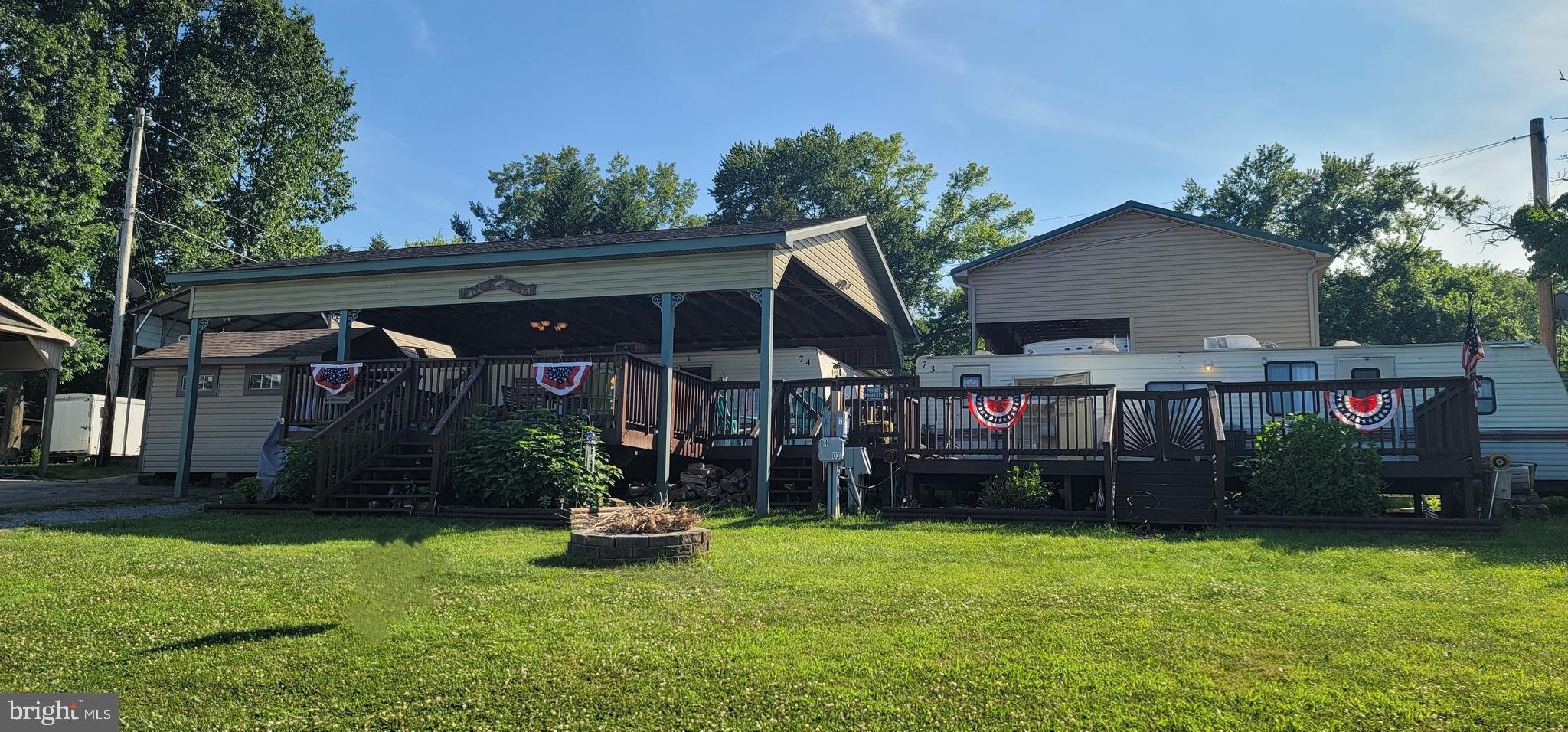 Get your Summer started in River Bend Park! TWO lots with two campers (1997 and 2004), deck and camper & deck cover, even the golf cart! Large deck has plenty of room for entertaining or just relaxing with each entrance being gated to keep your pups safe and enclosed. The 2004 camper has a private bedroom, a private bunk room, a full bathroom with tub and lots of living space or the table and couch can be pulled out to be used as additional sleeping areas. The 1997 camper has been recently updated and made into a perfect bunk-house for your kids, grandkids, visiting friends and family, etc. It includes a large living space with storage cabinets and cubbies (no kitchen), a private bath w/stand up shower and 2 private bedroom areas. River Bend is a 400 acre seasonal community open from April 1 to November 1. Located along 10 miles of deep water on the Potomac River allowing for recreational activities like boating, fishing, swimming, kayaking, canoeing along with many community activities like swimming pools, boat club, trick or treating, basketball court, tennis court, fireworks, car show, playground, bar and restaurant and so many more.