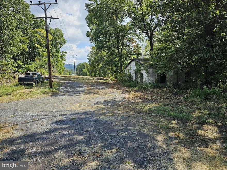 APPROXIMATELY 500 FT OF ROAD FRONTAGE - STRUCTURE ON LAND (NEEDS MUCH WORK...NO VALUE) WATER - SEWER & ELECTRIC AT ROAD - 2 POSSIBLE ENTRANCES OR DRIVE THRU POSSIBLE - ZONED RESIDENTIAL/COMMERCIAL