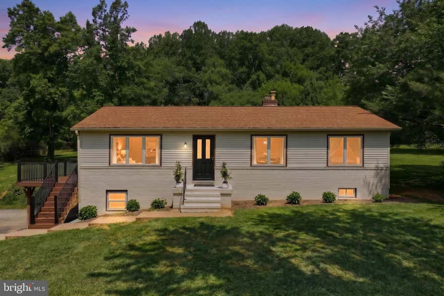 Welcome to 5007 Woods Road, a beautifully updated home set on 2.05 acres that makes it easy to picture yourself living here. Step inside to luxury vinyl plank flooring that flows throughout the entire home, beginning with a bright living room to the left where large windows fill the space with natural light, and continuing into the dining room. The kitchen is both stylish and functional, featuring black granite countertops, matte black appliances with eye-catching gold finishes, a skylight, and a walk-in pantry with built-in shelving and drawers for added organization. Down the hallway, you’ll find the bedrooms and a full bathroom with crisp white finishes and built-in shelving in the tub and shower. The primary bedroom offers an attached bathroom with a walk-in shower, along with two additional bedrooms, one currently used as a spacious walk-in closet complete with shelving that can remain and truly feels like every girl’s dream. Head downstairs and you’re immediately welcomed into an additional living room with a wood-burning fireplace. Just around the corner is the laundry room, with a half bath located right next to it and a sauna within the same space, perfect for unwinding after a long day or enjoying a spa-like experience at home. Just off the kitchen, the sunroom features built-in shelving and a skylight and is the perfect place to grab your morning coffee or hot tea and enjoy the natural light. A glass door leads from the sunroom to the large deck built just one year ago, overlooking scenic backyard views and tall trees, making it an ideal spot for grilling out and spending time with family and friends. Outside, the property also includes a convenient storage shed, providing extra space for tools, equipment, or outdoor essentials. Completing the home is a two-car garage equipped with an electric car charger, offering both convenience and modern functionality. Are you ready to make this move-in-ready home your very own? Schedule your showing today and don’t miss this amazing opportunity!!