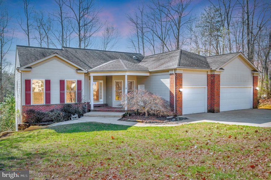 Stately Home in Sought-After Aquia Harbour Spacious and well-maintained, this 5,148 sq ft raised rambler sits on top of a rolling, 0.89-acre corner lot in the highly desirable Aquia Harbour community—just 10 minutes from Quantico Marine Corps Base. Built in 1996, this home combines timeless charm with modern updates. A wrought iron fence frames the property, and a large concrete driveway leads to a three-car garage with remote access. In the back, a custom three-tier Trex deck, in addition to an attached screened-in porch, overlooks mature trees—perfect for entertaining, relaxing, or enjoying quiet mornings with coffee or evenings under the stars. Inside, gleaming hardwood floors run throughout the main level. The living room and sunroom share a double-sided fireplace, adding warmth and character. The kitchen features upgraded Granite countertops, a breakfast bar with seating, and an adjacent breakfast room. The primary upper suite includes private deck access for quiet mornings or evening tea. The primary bedroom contains a spacious en-suite bath with double vanity, a jacuzzi tub, separate shower, and water closet, and two walk-in closets. The laundry utility room is also on the main level and includes an extra refrigerator and freezer. The finished lower level offers a large game room with theater seating and a movie projector, a generous storage area, two additional bedrooms, a business or workout room, a full bath, and walk-out access to a stamped concrete patio. A full-home Generac generator conveys—no need to worry about power outages. Enjoy all that Aquia Harbour offers: multiple parks, swimming pools, ball fields, golf course, marina, horse stables, and more. This home is a rare opportunity in a premier community.