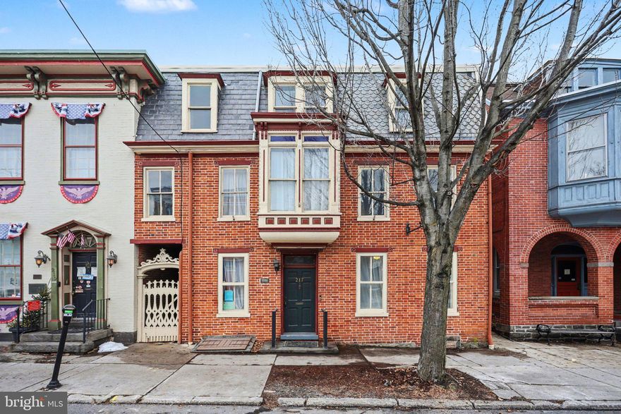 Welcome to 217 Baltimore Street - a timeless all-brick historic home offering over 3,500 sq ft of beautifully updated living space in the heart of Gettysburg. This 5 bedroom, 3.5 bath home blends classic character with thoughtful modern updates, featuring  a new roof, new HVAC, hardwood floors, fresh paint, wood burning insert fireplace and a newly added handicap-accessible full bath on the main level. The newly renovated West Wing just off the kitchen is filled with natural light, showcasing new windows, natural stone tile, and views of the private fenced backyard with a charming wisteria-covered pergola—perfect for morning coffee or quiet evenings.The second floor offers a spacious primary suite with a partially private balcony and an updated bath with a double vanity and brand new soaking tub, along with two additional bedrooms full of personality. A cozy study with built-ins, passthrough room with cabinetry, and a generously sized laundry room add both function and flexibility. The third floor continues the home’s historic appeal with newly refinished hardwood floors, exposed brick, and transom windows, plus an updated full bath and a bonus room with potential for a kitchenette. Additional highlights include a newly installed exterior staircase for easy access to all levels and the private backyard complete with an old-fashioned light post, old smokehouse used as a tool shed and an oversized detached garage for valuable off-street parking. This home is also zoned residential office leaving endless possibilities such as a B&B, restaurant, history museum and so much more. A rare opportunity to own a piece of Gettysburg’s charm—just moments from downtown shops, dining, and history.