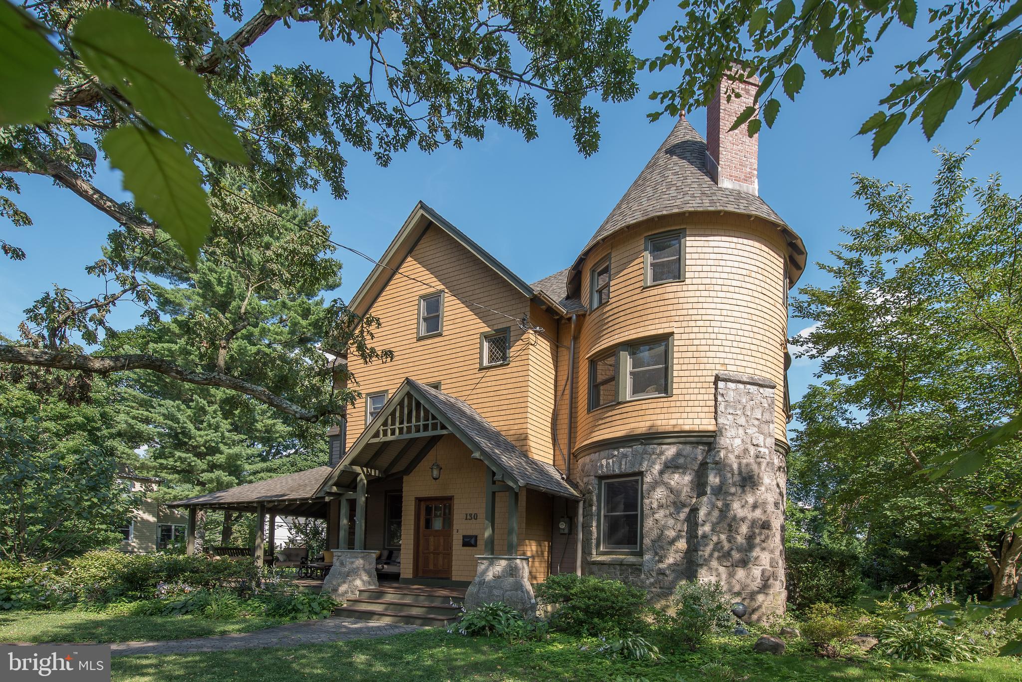 Don’t miss this extensively RENOVATED, 6-7 Bedroom, 5/1 Bath Arts & Crafts style home which features a stunning combination of historic charm and modern amenities. Welcome guests in the Center Entrance Hall, which is flanked by a Living Room and a charming Office/Library with fireplace. Behind the Library is a gracious Dining Room which can accommodate the largest of dinner parties. The fabulous Butler’s Pantry features a custom wine cork backsplash, refrigerator drawers, sink, icemaker, and a wall of display and storage cabinets. You’ll love entertaining and preparing meals in the expansive gourmet Kitchen, which features a generous island with barstool seating for 6, granite counters, and 3 walls of custom cabinetry. Appliances include a large SubZero frig, 48” Wolf gas cooktop with infrared charbroiler, Wolf double wall ovens, Bosch dishwasher, and Sharp microwave drawer. Large windows flood this room with light, and the floor plan has coveted open flow to the Breakfast Room and Family Room. Coffered ceilings flow through these rooms. Relax in the sunny Family Room, which has a gas fireplace flanked by built-in cabinets, and large windows overlooking scenic outdoor space. A spacious rear Entrance Hall flows into the Kitchen and opens to a Mudroom with storage cabinets, a built-in bench, walk-in Pantry, a Half Bath, and access to rear stairs and the wrap-around porch. This home features over 6,000 s.f. of beautifully maintained space, featuring vintage millwork, gleaming new wood floors with inlay border accents, and abundant custom built-ins and storage.
A soaring 3-story restored staircase leads upstairs, where you’ll find a very large Sitting Room with windows overlooking the rear yard. Privately nestled in the rear wing of the home is the Primary Bedroom, with two capacious walk-in closets, and a luxurious Primary BA with vaulted ceiling, radiant heat floors, double vanity, large tub, separate shower, and separate toilet room. Bedroom 2 features a private sitting room in the “tower” plus an en suite renovated 2nd full BA. Bedroom 3 has a charming double-bed nook, walk-in closet, and en suite access to the renovated 3rd full BA. A spacious Laundry Room with built-in cabinets and linen closets completes the 2nd floor. Upstairs are 3 more Bedrooms, 2 more en suite full Bath’s with hall access, plus a charming Office/possible 7th BD in the turret of this home. Downstairs, the mostly unfinished lower level features a 500-bottle wine cellar, ample storage and workshop areas, and steps to the side yard. All systems, including the roof, siding, windows, electrical, plumbing, and HVAC have been meticulously updated by the sellers. Sit and chat with friends on the wrap-around covered front porch, enjoy dining al fresco on the expansive rear flagstone patio, and cooking at the built-in stainless gas grill workstation. The rear yard is bordered by mature shrubs and trees for privacy, accented by specimen plantings, and features a pastoral water feature with a fountain. Protect your vehicles in inclement weather in the detached, oversized (30’ x 24’), 2-story Garage, which was built in 2004 on land which was purchased from a neighboring property. The walk-up, unfinished 2nd floor of this Carriage House is floored for convenient storage, has large windows, and offers great potential for additional living space. This is a rare “Tower House” model, designed by the renowned architects Frank L. & Will L. Price and built by Wendell & Smith (c.1887-1888). It is centrally located on a quiet street in the historic North Wayne neighborhood, which has a warm sense of community, with a directory and activities like progressive dinners, annual soap box derby, and more. Located in top-ranked Radnor Township School District, this home is just a 5-minute stroll from the train station, shops, and restaurants in the charming village of Waynconvenient to schools, parks, Center City, corporate centers, and Airport.