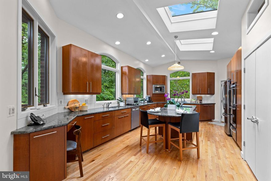 LAKE BARCROFT - WATERFRONT DEAL! - Enjoy the best of Lake Barcroft living in this beautifully renovated 3BR/3.5BA home on a quiet cul-de-sac with a waterfront dock! Featuring soaring ceilings, walls of windows, and gleaming hardwoods, this contemporary offers a light-filled retreat surrounded by nature — all at a newly reduced price.

Highlights include:
• A spacious open-concept main level with a sun-drenched living room anchored by a striking travertine-surrounded gas fireplace.
• Dining room with elegant chandelier flowing into the sitting room 
• Stunning updated kitchen boasting cathedral ceilings, skylights, and expansive windows overlooking the wooded lot.  The kitchen features granite counters, large island, custom cabinetry, pantry, stainless-steel appliances.
• Multiple decks with woodland views, giving the home a serene, treehouse feel. Follow a wooded path to your waterfront dock — which offers plenty of space to park and launch your boats, including a pontoon boat! While the home is nestled in the trees, the waterfront dock gives you direct access to Lake Barcroft for boating, swimming, fishing and fun!
• Main-level primary suite with deck access and a spa-inspired bath featuring limestone tile, dual vanities, and walk-in shower.
• Walk-out lower level with oversized family room, wood-burning fireplace, sliding glass doors to a paver patio, plus a second ensuite bedroom, additional bedroom, hall bath, and versatile bonus room.
• Half-acre wooded lot with lush landscaping, koi pond, screened porch, and multiple outdoor living spaces.
• Convenient attached 2-car garage and large paver driveway.

This home is a fantastic entry point into Lake Barcroft waterfront living — offering a waterfront dock, updated interiors, and peaceful wooded surroundings. Fabulous location, just blocks to Lake Barcroft's private beaches, easy access to major commuter routes (Routes 50/66/395/495), and is only minutes to Tysons, Arlington, and Washington, DC.