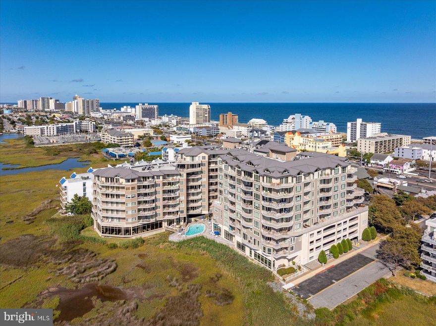 Absolutely stunning remodeled luxury bayfront condominium at the Rivendell.  Step into this 3 bedroom 3 bathroom residence and you will immediately notice the new luxury vinyl plank flooring throughout.  The flooring provides seamless transitions from hallways to bedrooms and bathrooms.  The kitchen and bar area are beautiful and modern with new quartz countertops and stylish upgraded cabinetry featuring new paint and hardware.  You and your guests will appreciate that each bedroom has an attached bathroom with new vanities.  The hallway bathroom that is shared with a guest bedroom recently had a sliding glass door installed so that you can see the Ocean, Bay, and City views from the shower window.  Other improvements include new tranquil paint throughout including walls, trim, and doors and a brand-new bedroom set in the primary bedroom.  The new dresser and mirror will be delivered in the next two weeks.  Sold fully furnished with decor exclusions (see inventory addendum).  The Rivendell complex is a secure access luxury bayfront community that features a beautiful lobby, year-round heated indoor pool, fitness center, outdoor pool, and on-site restaurant.  Located on 81st street that features a traffic light and crosswalk to the beach once you park your vehicle in the covered parking garage, all amenities are conveniently nearby.  This is a non-rental building.  This is a must-see property and is ready to be enjoyed for the upcoming Summer of 2026!