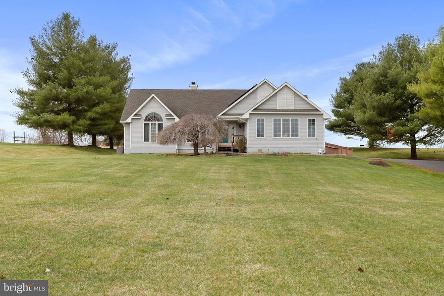 Welcome home!! Step inside to be greeted by a warm and inviting atmosphere, ample natural light, freshly painted rooms and refinished luxury vinyl plank floors. The spacious living room boasts a cozy fireplace, ideal for gathering with loved ones on chilly evenings. The heart of the home is the stunning chef's kitchen, featuring gleaming granite countertops, new appliances, and custom cabinetry. With all the custom details this kitchen is sure to delight even the most discerning chef. Retreat to the luxurious primary suite, complete with a spa-like ensuite bathroom and private access to the backyard. Primary bathroom has a fully tiled, wheelchair accessible shower. Two additional bedrooms offer comfort and flexibility for family and guests alike. The main level is fully wheelchair accessible with 2 entry points with a ramp to the outside area. Downstairs, discover a hidden gem - a fully renovated basement level apartment, complete with its own entrance, kitchen, and stylish bar area. Perfect for guests, in-laws, or potential rental income, this space offers endless possibilities. We can't forget to mention the hidden secret room on this property, you need to see for yourself! This home is in a great commuter location, close to all the amenities Martinsburg and Charles Town  have to offer, while remaining in a peaceful country setting. All of this and more on just under an acre of property. Do not miss the opportunity to see this one of a kind property!