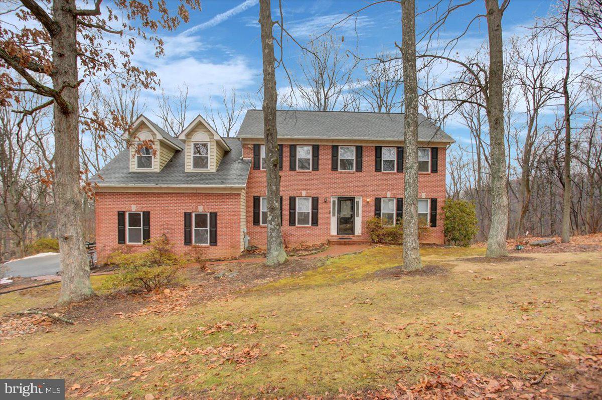 **OFFER Accepted! Open house and offer deadline cancelled!**Nestled in a serene rural setting, this charming 5-bedroom, 3.5-bath colonial home offers the perfect blend of tranquility and convenience. Over the past five years, significant updates have been made, including a new 50 year roof, HVAC system, water heater, and more, ensuring peace of mind for the new owners. The main level features beautiful hardwood floors throughout, leading to a spacious kitchen with granite countertops, a center island with a cooktop, and ample cabinet space. The cozy living room, complete with a wood-burning fireplace, provides a warm and inviting atmosphere. The primary bedroom suite is a true retreat, boasting a walk-in closet and an ensuite bath with a jetted tub and separate shower. The upper level has a unique layout, featuring a third bedroom with an adjoining room, perfect for a nursery or dressing room. The fourth bedroom is a large space above the garage, ideal for an office, workout area, or a spacious bedroom. The lower level is mostly finished, offering a fifth bedroom, a recreation room with a cozy pellet stove, at-level walkout access, utility/storage room, and a full bath. Convenient main floor laundry room with some storage and deep sink. The property spans 1.84 acres, adorned with mature trees and abundant wildlife, creating a picturesque and private retreat. When spring arrives you will see a burst of color and the many flowering trees and bulbs in the flower beds wake up from their winter sleep! Outdoor living space features approx. 600 sq ft of deck to enjoy the sunset through the trees. Despite its peaceful surroundings, the home is just a short drive from town amenities, including restaurants and shopping, providing the best of both worlds. This beautiful property is ready to welcome you home.