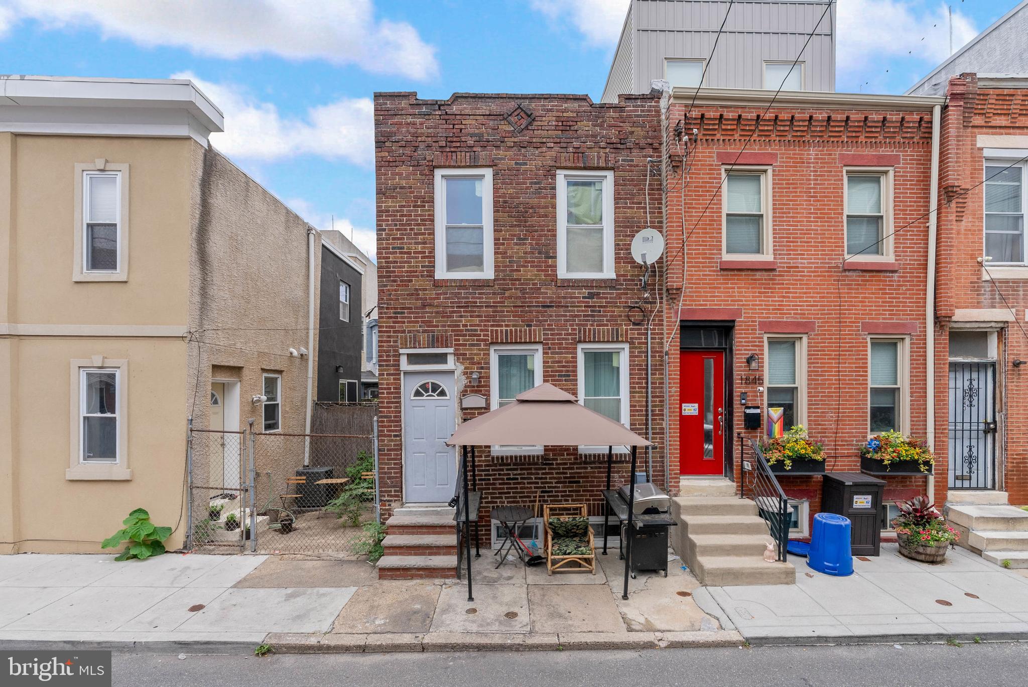 Located on a quiet Point Breeze block, surrounded by rehabs and new construction, 1847 Gerritt Street is a renovated 2-story home offering 2 bedrooms, 1.5 bathrooms, a finished basement, super low taxes and central air conditioning. This home presents a fantastic opportunity for an owner-occupant willing to put in some TLC or an investor looking to build equity in a prime neighborhood. Out front, you're greeted by a classic brick facade. Inside, hardwood floors stretch across the bright, open, and airy main level. Natural light pours into the living room, where there's plenty of space to hang out, while the dining area can accommodate a large table for entertaining. The updated kitchen is fitted with inset cabinetry, granite counters, stainless steel appliances, including a dishwasher, a tile backsplash, and a center island. Upstairs, a huge primary bedroom (this used to be 2 bedrooms, combined to 1) with double closets at the front. A full bathroom and bright bedroom are down the hall. Completing the home is a finished basement with more living space, perfect for a playroom or gym, laundry, and a half bathroom. In addition to everything inside, 1847 Gerritt Street earns a Walk Score of 81! Top restaurants, friendly shops, and local markets are steps away. Popular stores like Target, Sprouts Farmers Market, and GIANT are nearby at Broad & Washington, plus Wharton Square Park and Chew Playground are close. There's also easy access to public transit, I-76, and University City. Schedule your tour today!