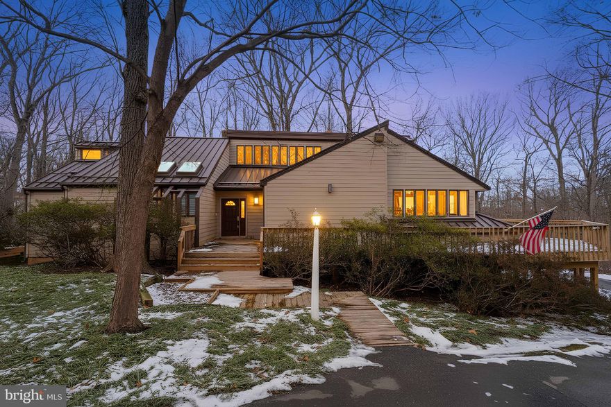 I am excited to share details about a truly unique property that has just become available for the first time.  Offering an exceptional living experience.  This custom-built contemporary home is perfectly situated on just over 3 acres of private, wooded paradise​ at the end of a flag lot. Pet friendly with an invisible fence already installed.
The residence features a striking open floor plan on the main level with high ceilings and exposed beams, creating an airy and sophisticated but comfy atmosphere.  The large kitchen is a chef's delight, equipped with abundant cabinetry, new appliances including a double built-in oven, dishwasher and french door fridge, also the kitchen has a trash compactor, a separate prep-sink,  and a spacious kitchen island.  There's also a kitchen bar with room for 5 chairs.  The granite countertop extends to a sunny bay window, perfect for showcasing your plant collection.  Both the living room and the family room open to a wrap-around deck, with the family room also featuring a wood-burning fireplace.
The main level is also home to a luxurious master suite, which includes an expansive sitting room with a cozy fireplace, separate "His and Her" bathrooms, and an extra-large walk-in closet complete with custom built-ins and a cedar closet. Her bathroom includes a separate bidet.  Master bathroom also has a large walk-in shower, and an extra-large soaking tub.   A convenient side entrance leads into a mudroom with a pet bath and ample closet space.  This home was thoughtfully built with space for an elevator, which can be utilized now or in the future; otherwise, both levels offer extra-large closet space.
The lower level provides additional generous living space with three bedrooms and two full bathrooms, offering comfort and privacy for family or guests.  This walk-out level boasts large windows, which is bright and inviting. It also includes a large family room, a pool table, and a wet bar.  The property features a three-car garage which enters into the lower level, along with an extra workshop area.  In total, the home boasts four bedrooms and​ three and a half bathrooms, designed with both elegance and functionality in mind.
This property offers a rare opportunity to own a contemporary masterpiece in a serene natural setting. Please let me know if you would like more information or to schedule a private viewing.  ​Interior photos and layout to come.