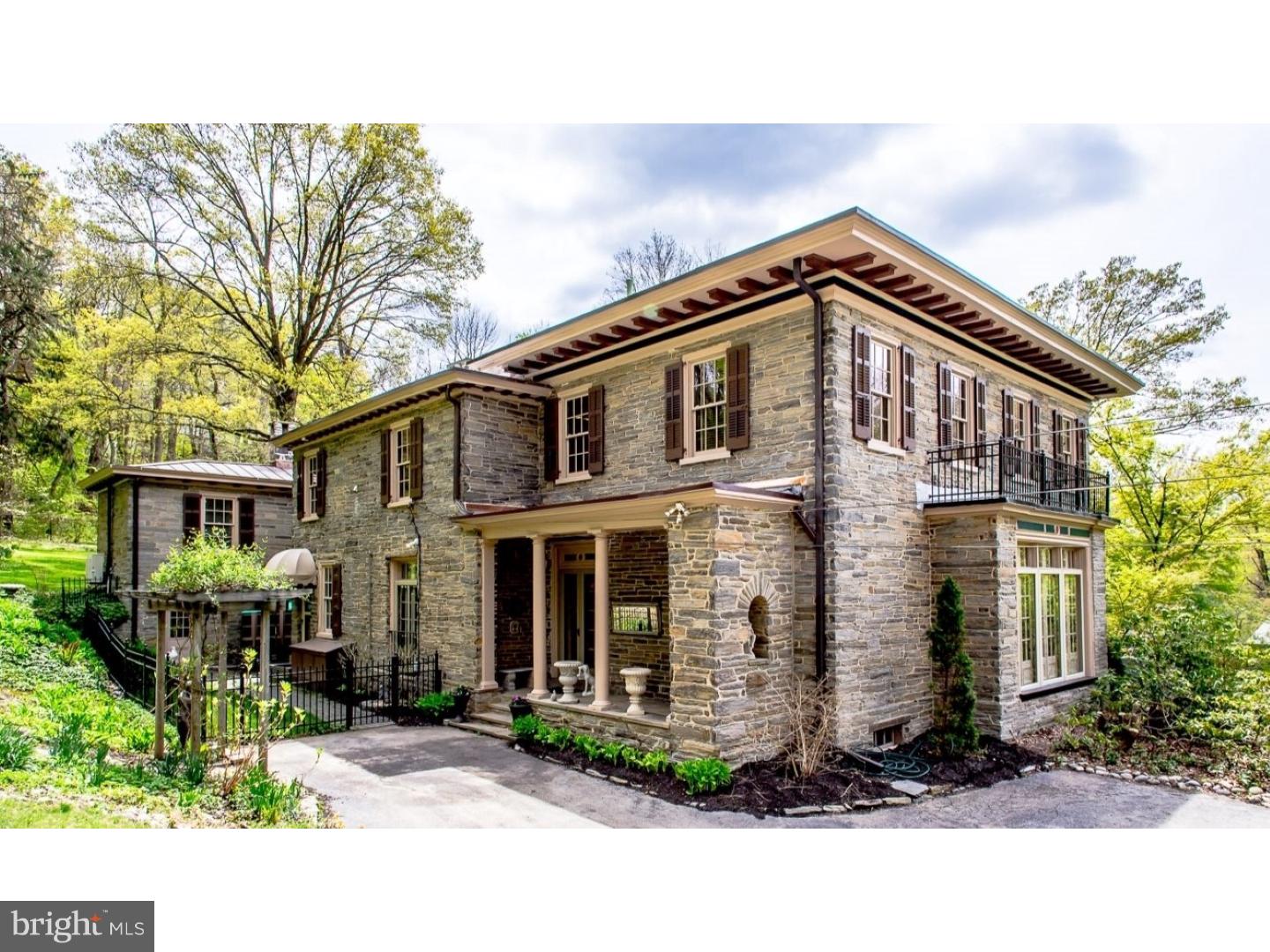 Welcome to 30 West Bells Mill Road. This stone, Italianate-style home sits on 2.35 acres with views of the Wissahickon Valley Park in Chestnut Hill. Steeped in history, the original house was built in 1847 and later expanded and renovated in 1917 by Philadelphia architect Marmaduke Tilden as a summer residence for Daniel Haddock Farr, a prominent New York antiques dealer, and his family. Intricate moldings, millwork and elaborately carved cornices were reclaimed from 18th century Society Hill townhouses, including the Powel House. While maintaining the incredible original details and integrity of this significant home, it has been thoughtfully restored, updated and maintained by its current owners. Enter through the side French doors into a grand central foyer with Carrera marble floor and stately curved staircase. Large living room with 10.5 foot ceiling, antique marble fireplace and French doors allow perfect natural light into this grand entertaining salon. Large dining room with antique fireplace and French doors to the terrace leads to fully updated eat-in kitchen with granite counters, stainless steel appliances, large pantry and great storage. Off the kitchen, at the rear of the house, is a family room with woodstove and abundant windows and doors overlooking the outdoor living space and wooded grounds. Above is an au-pair suite complete with separate entrance, laundry room, sitting room, bedroom, breakfast bar and full bathroom. On the second floor, at the front of the house, 3 generous sized bedrooms, one with Juliet balcony overlooking the grounds, including bluestone terraces, fountain, meandering walkways and paths, and Samuel Yellin ironwork. A Roman style pool as well as perennial flower beds and mature specimen trees complete this very private, park-like setting. Master-suite oasis features large bedroom with antique marble fireplace and separate sitting room/dressing room with walk-in closet with custom built-ins. Updated master bathroom features spa tub, walk-in shower and second laundry. Separate guest cottage features living room with beautiful millwork, bedroom with full bathroom, full eat-in kitchen and 2-car attached garage. Circular driveway provides off-street parking for 18 cars. Marvin double-pane windows throughout the house, and 4 fireplaces. Walking distance to Fairmount Park's Forbidden Drive and just a short distance from the 'top of the hill'.
