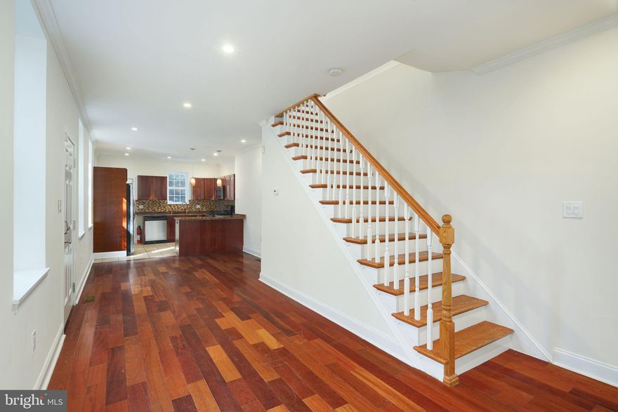 Granite Countertops w/ Glass Mosaic Backsplash.  All Stainless Appliances.  Brazillian Cherry    Hardwood Floors throughout.  Recessed Lighting.  Natural Stone Tile Bathrooms. Energy Efficient LowE Windows.  Brand New Central Air and Heat.  Finished Basement with MiraDrain  Basement Dry System.    Private Rear Courtyard.