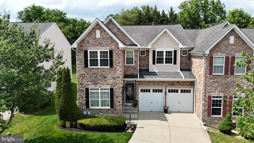 Meticulously maintained and loaded with upgrades, this stunning 4-bedroom, 3.5-bath stone-front colonial sits proudly at the end of a private cul-de-sac, offering over 4,000 finished square feet of living space ready to impress. Step into a welcoming foyer with hardwood floors that lead into an inviting living room and an elegant dining room featuring hardwood floors, crown molding, chair railing, and wainscoting. The gorgeous gourmet kitchen showcases hardwood floors, granite countertops, an island, stainless steel appliances that are brand new—less than 6 months old, and a stylish tile backsplash. Just off the kitchen, you’ll find an incredible 2-story family room with 9-foot ceilings, a cozy gas fireplace, a ceiling fan, and plenty of natural light. The main level also includes a private office or den with crown molding and a ceiling fan, a convenient half bath, and a separate laundry area with a brand new washer and dryer installed less than 6 months ago.

Upstairs, the spacious primary suite offers two closets and a luxurious master bath complete with a spa soaking tub. Three additional generously sized bedrooms and a full bath provide plenty of room for everyone. The fully finished walkout lower level is an entertainer’s dream or the perfect in-law suite, featuring a huge open area with a full kitchen, a full bathroom, space for a dining area, a living room, and a potential bedroom setup. You’ll also find a recreation room with built-ins, recessed lighting, along with a bonus room perfect for a gym, guest space, or play area, plus extra storage. For peace of mind, one of the HVAC systems was just replaced less than 3 months ago.

Outside, you’ll love the beautiful custom paver patio surrounded by hardscape and lush landscaping, perfect for relaxing evenings or hosting gatherings. An attached front-loading two-car garage completes this impressive property. This home truly has so much to offer—come take a look before it’s gone!

Schedule your private showing today!