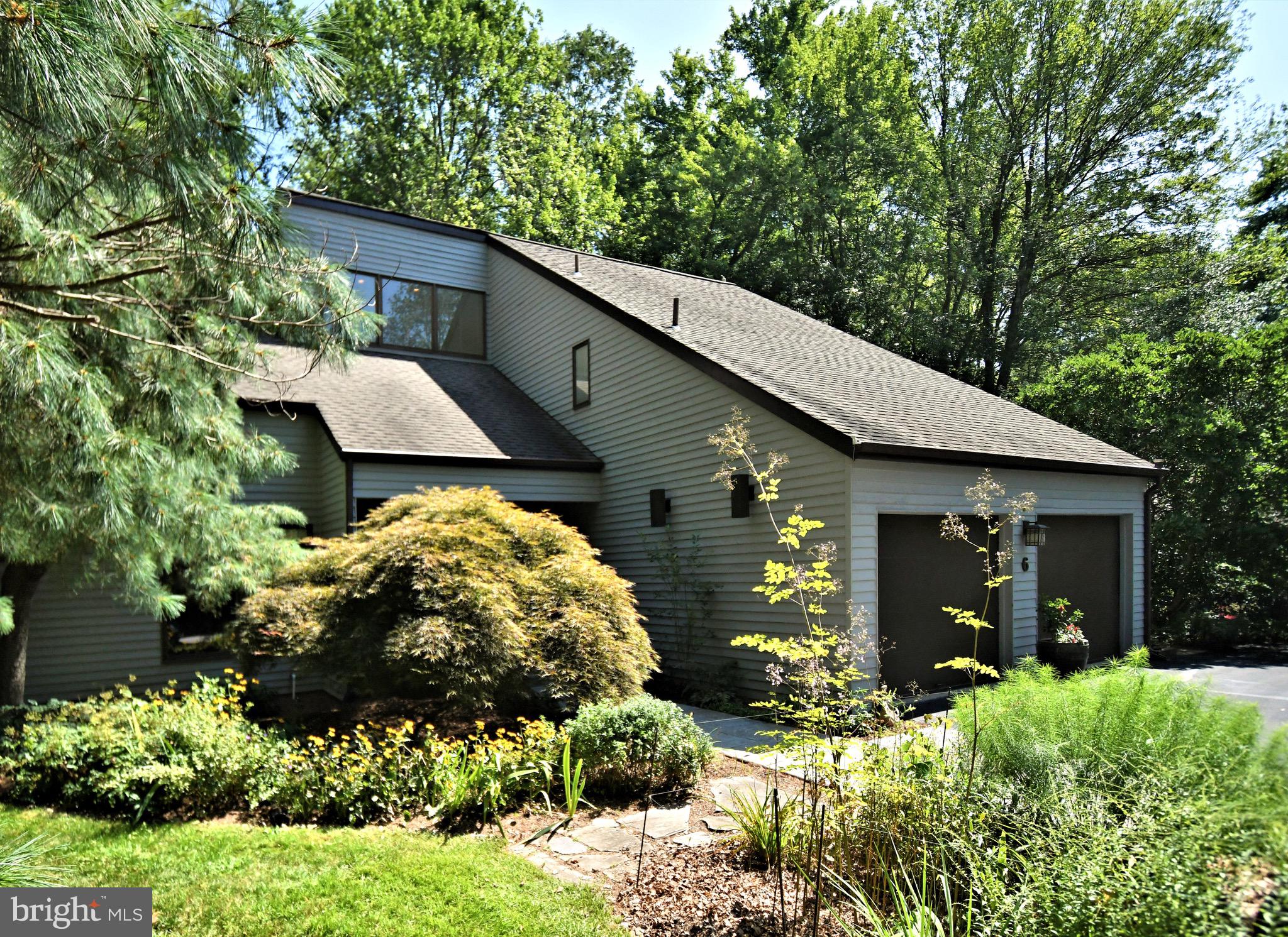 Welcome to 6 Timber Fare – a meticulously maintained residence in the sought-after Wood Bridge Meadow community of Lower Gwynedd. This exceptional home is truly one of a kind. If you’re not yet familiar with Wood Bridge Meadow, prepare to be impressed. Nestled in the heart of Lower Gwynedd, this thoughtfully planned neighborhood spans 52 wooded acres, complete with scenic walking trails and three ponds.
Each home here is unique, and 6 Timber Fare is no exception. Privately tucked into a small cul-de-sac, this contemporary residence, clad in warm western red cedar siding, offers both charm and sophistication. From the moment you step inside, the open sightline from the foyer to the back gardens—framed by mature plantings and trees—sets the tone. Expansive Pella windows and gleaming hardwood floors invite you into every well-designed space.
To the left, the spacious living room flows into a dedicated dining room with a vaulted ceiling—perfect for hosting large gatherings. The dining room seamlessly connects to the gourmet kitchen, featuring cork floors, custom shaker-style cherry cabinetry with abundant drawer storage, a large pantry, a convection oven with a warming drawer, extensive counter space, and a custom backsplash.
An airy addition houses a timber frame sunroom, complete with skylights and surrounding casement windows—ideal for curling up with a good book or soaking in nature’s beauty. This level also includes another generous living area, a mudroom, and a half bath.
Open-concept stairs lead to the upper level, where you’ll find three large guest bedrooms, a spacious hall bath, and a laundry area, plus the primary suite with a dedicated bathroom and vanity area. The finished basement expands the living space with a kitchen area, two separate living zones, ample storage, and a workshop.
The oversized two-car garage, two HVAC systems, three heating zones, and two A/C zones ensure year-round comfort and efficiency. Outside, the low-maintenance yard is enhanced by an irrigation system, making it easy to enjoy your private outdoor oasis.
Wood Bridge Meadows offers a rare combination of natural beauty and convenience—just minutes from The Spring House Village, Whole Foods, Downtown Ambler, Regional Rail, and major commuter routes.
