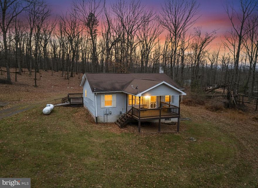 Your ideal mountain retreat awaits! Nestled on 4.68 acres, this 2-bedroom, 2-full bath home offers exceptional privacy, peaceful wooded surroundings, and room to expand. Perfect as a weekend escape or a full-time residence, the property features hardwood floors, a spacious primary bedroom, two full baths, and a well-appointed galley kitchen with stainless steel appliances. Convenient main-level laundry just off the kitchen and a full unfinished basement provide added flexibility and future potential. Enjoy the outdoors from your covered front porch or rear deck, and take advantage of the additional storage shed on-site. If you’re looking for tranquility, space, and a true mountain getaway, this is it. Schedule your visit today!