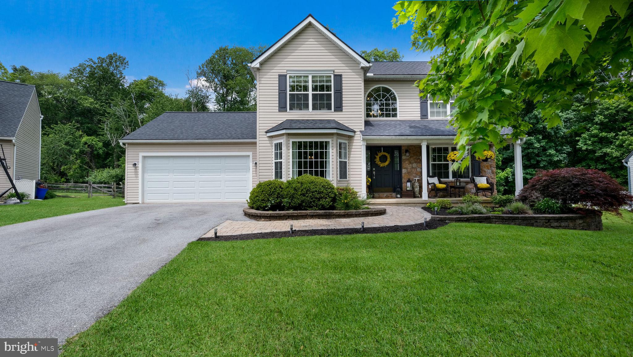3-Bedroom, 2.5 bathroom home on a cul-de-sac with community playgrounds and walking trails. This home has been impeccably maintained and thoughtfully updated, including a brand-new roof, recessed lighting throughout and numerous fashionable accents. The updated custom kitchen features a breakfast island, coffee bar, soft-close cabinets, and subway tile backsplash. A glass door from the kitchen opens onto the expansive rear deck. The kitchen has plenty of space for a breakfast table, and is wide open to the comfortable family room, accented by a wood-burning fireplace with a slate hearth and elegant mantel piece. Outside, a large deck overlooks the fully fenced, level back yard with raised garden beds and views of the woods. The front living room has custom built-in bookshelves and cabinets, while across the foyer, the dining room has an elegant bay window. A convenient powder room is available off the foyer. Upstairs, the primary bedroom suite includes a bathroom with a stall shower and a soaking tub, plus a large walk-in closet. Also on this level are two additional bedrooms. One is currently set up as an office with a custom ship-lap accent wall. On the lower level of the home is a fully finished bonus room, currently used as a home gym. This level has plenty of storage space in closets, and a large laundry room with additional storage. Inside access from the kitchen to the two-car garage, which is currently set up as a carpentry workshop.