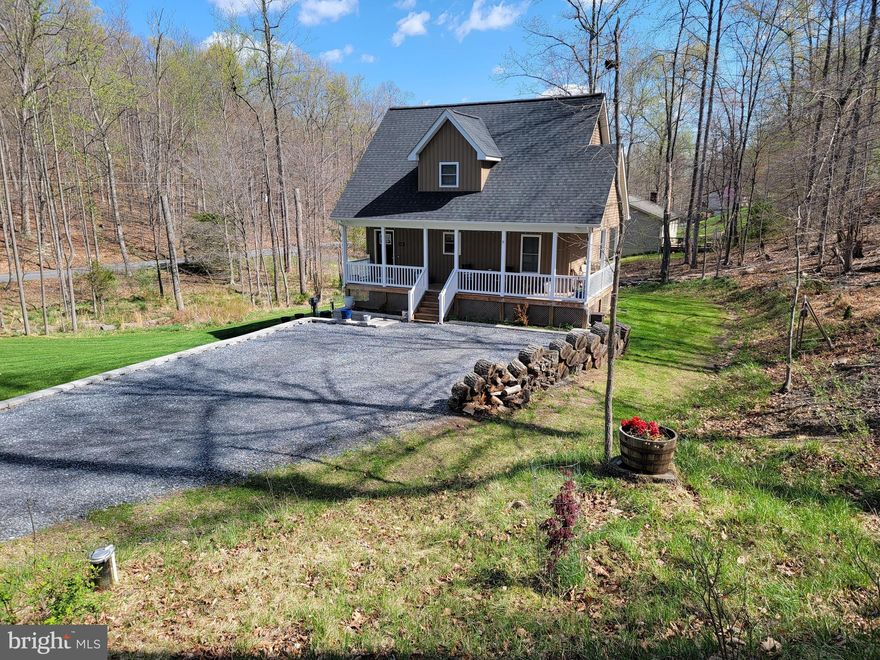 Beautiful Cape Cod Style only 3 years old.  One acre lot at bottom of Apple Mountain Lake. No steep Hills to worry about.  Covered  Wrap around Porch, 3 levels with unfinished walk out basement.  Also outside patio from basement and shed.  3 bedrooms and 2.5 Baths with a rough in for a future bath in the basement. There is a main level master bedroom with private bath.  Home shows very well and Owners have done a lot in 3 years.  It is very cozy.  Listing agent is related to the Seller. Septic = # bedrooms, alternative field.  Appointment only call first.  Ring Cameras Present on Property.