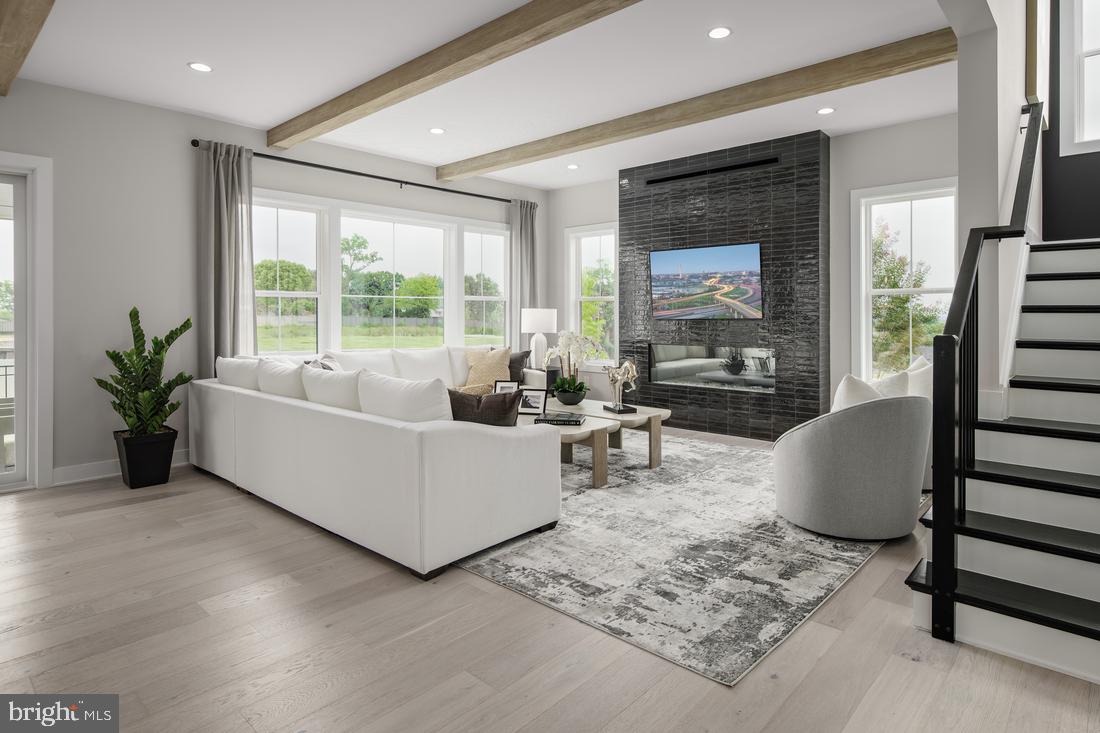 The Grove at Dominion Hills is Toll Brothers boutique single family home community in highly desired Arlington, VA. This 5 bedrooms, 5 ½ bathrooms, 2 car garage home with covered luxury outdoor living, is a Fall 2025 move-in ready home. It perfectly fits your lifestyle with premium finishes in the kitchen including JennAir stainless steel appliances, upgraded mid-century modern style cabinets and a large island perfect for entertaining. The open-concept kitchen flows effortlessly into the great room and casual dining room, making this floor plan ideal for the way you live. This home design has it all. Enter through your front door into a grand, light filled foyer with soaring 10’ ceilings, and a private office – ideal for work from home, playroom, craft room or den! As you make your way into this 4,570 sq ft home, cozy up in the great room with gas fireplace and luxury outdoor living space just off your casual dining area, enjoy summer evenings with your door open and retractable screens down. On the second floor a relaxing primary bedroom with en-suite bathroom with separate vanities, large linen closet, freestanding Kohler soaking tub, and walk-in shower. On this same level you have three additional generous sized bedrooms, all with walk-in closets and full baths. This level is also complete with a laundry room boasting cabinets and a utility sink. The finished lower level has a generous rec room, wet bar, bonus room, plus a bedroom and full bath, all for your convenience and a great place for guest to feel comfortable. Give us a call to schedule your appointment today, you will not want to miss out on this home!