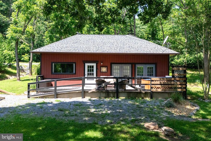 Everything you could want and more at Fox Den Cabin adjoining the George Washington National Forest with nearby access to the Shenandoah River! With its three-bedrooms and open concept, this cabin is the perfect investment opportunity or getaway retreat in the Shenandoah Valley. Convenient location less than two hours from Washington D.C. Currently this cabin is operating as a short-term vacation rental (STR) with river access just a few yards away! The public boat landing on the South Fork of the Shenandoah River is also just around the corner and so is the Shenandoah River Outfitters! Short-term vacation rentals are allowed by right on this property and the cabin has been successfully operating as one for years. Features include many new updates within the last several years, including a major interior remodel, a new roof, and new gutters. A private deck provides the ideal outdoor space for entertaining / enjoying nature and to spend countless hours in the hot tub (which conveys)! Most furnishings also convey including brand new outside furniture, making this cabin a true turn-key short-term vacation rental. Additionally, this cabin is just a short distance from Luray Caverns, Shenandoah National Park (SNP), Kennedy's Peak hiking trail, and ADJOINS the George Washington National Forest (GWNF). Hikers, mountain bikers, bird watchers, kayakers, outdoor enthusiasts, and those just looking to get away from the hustle and bustle, this cabin is for you!