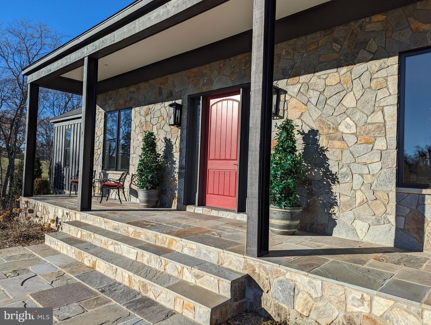 Welcome to a Modern home that's more than a masterpiece:  it’s the perfect canvas for your personal vision. Nestled within three expansive, rolling acres, approximately two miles west of Middleburg, this unique, custom build combines luxury with the beauty of natural surroundings. Designed with the art collector in mind, this residence offers generous wall space, allowing you to showcase your collection in rooms thoughtfully designed to highlight each piece. Every wall becomes a potential gallery, combining sophistication with self-expression.
Embrace main-level living and step onto the 5,000-square-foot main level, where ceilings soar to 10 feet, and an open floorplan unveils itself with a flourish. A mesmerizing 37 feet of sliding glass doors flood the family room with natural light, offering glimpses of a potential backyard oasis.
At the heart of this domain lies a kitchen that transcends culinary boundaries. A 48-inch, 5-burner Miele range takes center stage, flanked by a Miele wall oven, a built-in microwave, dual Asko dishwashers, and a Hoshizaki icemaker. The Wolf cabinets (throughout the entire home) marry style and functionality, culminating in a 13-foot island with resplendent waterfall granite:  a space where cooking transforms into a communal art form, where friends gather, sous chef duties are embraced, and memories are etched into the very essence of the home.
This stunning kitchen is combined with the massive living room with a gas fireplace and a bank of 37’ of sliding glass that dissolves the boundary between indoor and outdoor living. A large patio looks out onto the backyard. On the other side of the kitchen is the great room with 13’6” ceiling and a gas fireplace.
The main level unfolds further, revealing a formal dining room with an indulgent butler's pantry, a receiving room, a capacious mudroom, multiple closets, a half bath, a laundry room, a kitchen office, and a utility room – all thoughtfully designed to streamline and elevate everyday living.
Throughout the residence, thoughtful details intertwine seamlessly. Stunning chandeliers illuminate communal spaces, a chorus of 156 recessed lights illuminate dramatic spaces with Delorme switch plates, while custom 8-foot panel doors adorned with exquisite Emtech lever handles add a touch of grandeur. En-suite bedrooms boast deep, soaking tubs with beautiful fixtures and upgraded tile that reach the 10-foot ceilings, creating a striking visual impact. The engineered oak flooring adds a warm, inviting touch, harmonizing beautifully with the home's aesthetic. A beautiful, custom-built, bronze, twisted handrail takes you to the lower level. 
Descending to the lower walkout level, a realm of recreation unfolds. A large rec room, workout room, mini kitchen, laundry room, and yet another full bath reside. Two more en-suite bedrooms and a den/office invites creativity and contemplation. Pamper your four-legged companion in the doggy washroom complete with a doggy slipper tub. 
Let’s not forget the garages! Three garage spaces, illuminated by LED lights and an EV hookup under lofty 12.5-foot ceilings, stand ready to house all of your automotive treasures and secured by commercial grade, well-insulated garage doors.
Merely 2 miles west of Middleburg, high-speed internet and a quaint neighborhood ambiance intertwine. The small neighborhood is perfect for leisurely strolls, fostering a strong sense of community and providing a welcoming atmosphere.