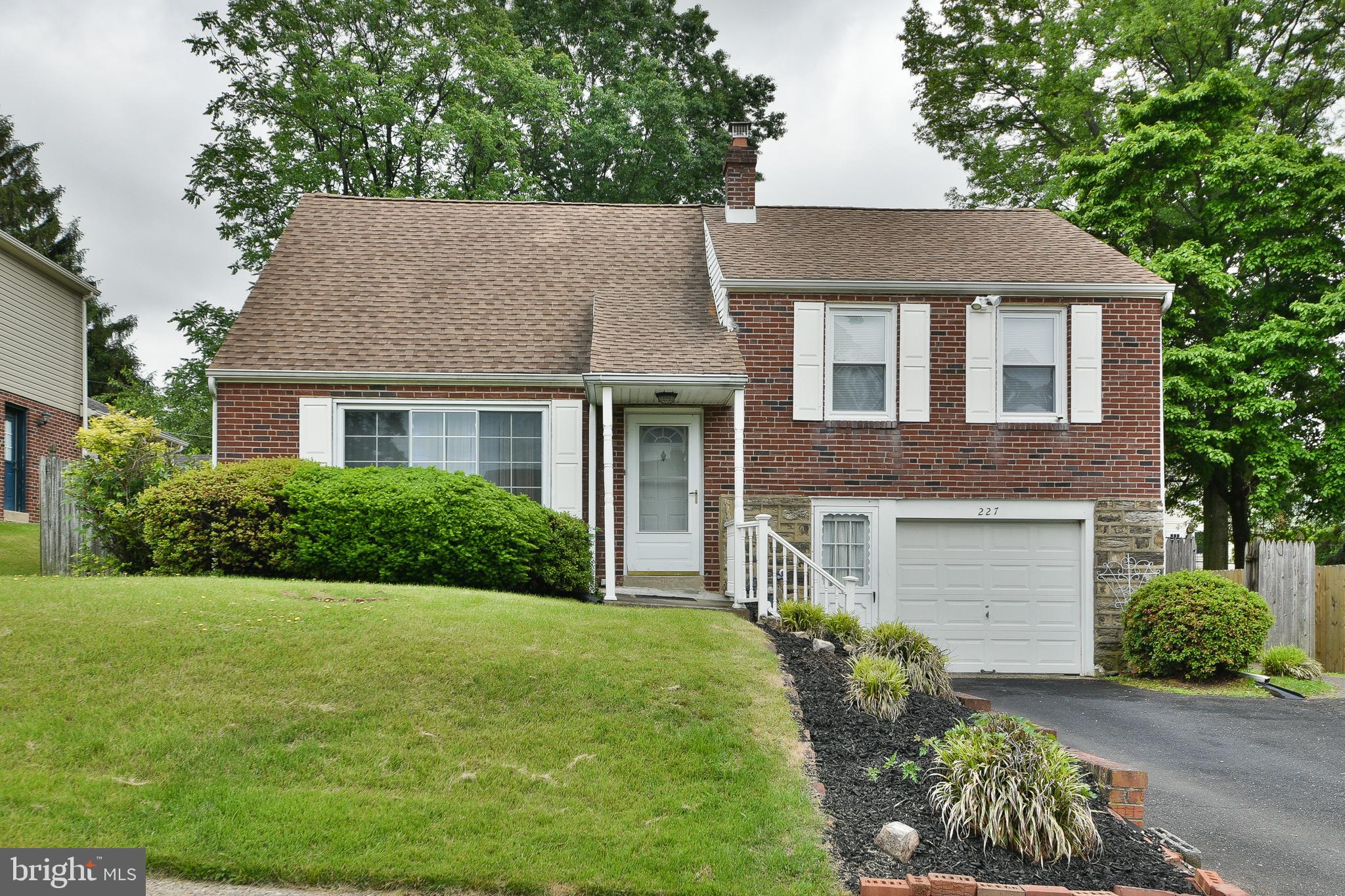 Welcome to your dream home in the heart of highly sought-after Abington Township, where charm meets convenience! This immaculate 3-story brick and stone beauty offers incredible space, thoughtful upgrades, and unbeatable value. Nestled in Elkins Park, enjoy proximity to fine dining, premier shopping, top fitness centers, and award-winning Abington School District—plus, you're just minutes from the train, downtown, swim clubs, tennis, and even Rita’s Water Ice! The expanded driveway leads to a private entrance, and the fully fenced backyard is ideal for entertaining—featuring a sunroom, stone patio, and lush yard perfect for gatherings. Inside, you'll find a bright, open layout with hardwood floors beneath plush new carpets, freshly painted walls, and a huge picture window in the living room. The dining room shines with a modern chandelier and sliding glass doors opening to the spacious sunroom. The updated kitchen boasts stainless steel appliances, a breakfast bar, tons of cabinet space, and low-maintenance flooring. The spacious sunroom offers panoramic backyard views and opens directly to your private patio—perfect for summer evenings. The finished lower level is currently used as a home office, but easily doubles as a family room, playroom, or rec room. A versatile third-floor space adds even more options: home office, guest suite, or 4th bedroom!