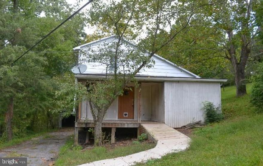 Nestled in a serene rural setting, this property provides an abundance of privacy with its location in a wooded area. Resting on a generous 1.5-acre plot of land, this home offers plenty of room to expand and explore.

While this property requires significant attention and repairs before it is move-in ready, it presents a unique opportunity for those seeking a project. The house itself demands renovation and care, but with some dedicated TLC, it has the potential to become a charming and comfortable living space.

One standout feature of this property is the detached 2-car garage situated at the back. With a little imagination and creativity, this garage could be transformed into a perfect workshop, providing ample space for hobbies or projects.

Beyond its potential as a primary residence, this property also holds promise as a great little getaway. With its tranquil surroundings and secluded location, it offers the opportunity to escape the hustle and bustle of daily life. With some thoughtful improvements, it could become a peaceful retreat for relaxation and rejuvenation.