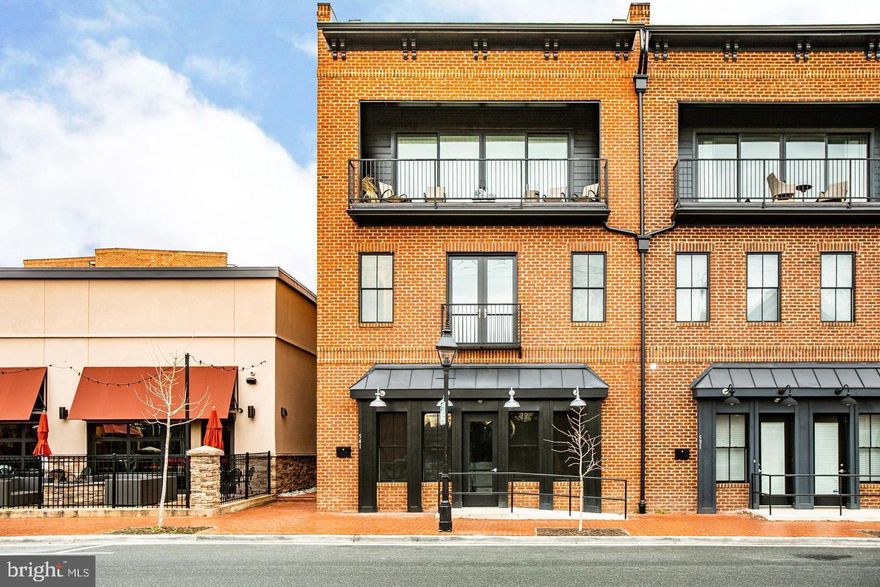 This home has it all—a crown jewel of Fredericksburg.  Nestled in the newest and most desirable stretch of downtown Fredericksburg, this rare modern build offers three spacious bedrooms and 4 luxurious bathrooms. The home features two very spacious living rooms, perfect for entertaining or relaxing.  With three balconies, including one off the primary bedroom, you can enjoy serene views and private outdoor spaces. The property boasts two beautifully designed kitchens equipped with top-of-the-line appliances, making it a culinary enthusiast's dream. Wide plank black hardwoods flow throughout, complemented by fresh paint and high ceilings, creating an open and airy atmosphere.  Unique to this property is a literal storefront on the first floor, providing extra space or an opportunity for an income-producing business. Garaged off-street parking ensures convenience, while the roof deck, reinforced to hold the weight of a hot tub or swim spa, promises unparalleled relaxation and leisure.   Modern conveniences abound with a four-story elevator, house humidifier, heated floor in the primary bathroom, and three gas fireplaces. Natural light floods the interior through four skylights, creating a warm and inviting atmosphere.  Situated on Downtown's "restaurant row" and steps away from local favorites like Sedona Taphouse, Blue Cow Ice Cream, and V Chophouse, this home is at the heart of Fredericksburg's vibrant scene. Enjoy the convenience of a park across the street and the charm of a walkable neighborhood.  Masterfully built with brick and embodying modern elegance, this home stands apart, providing a fresh and luxurious lifestyle. Whether you're entertaining guests or enjoying a private perch over FXBG, this exceptional property offers an unmatched living experience. Don’t miss out on this unique, one-of-a-kind home.