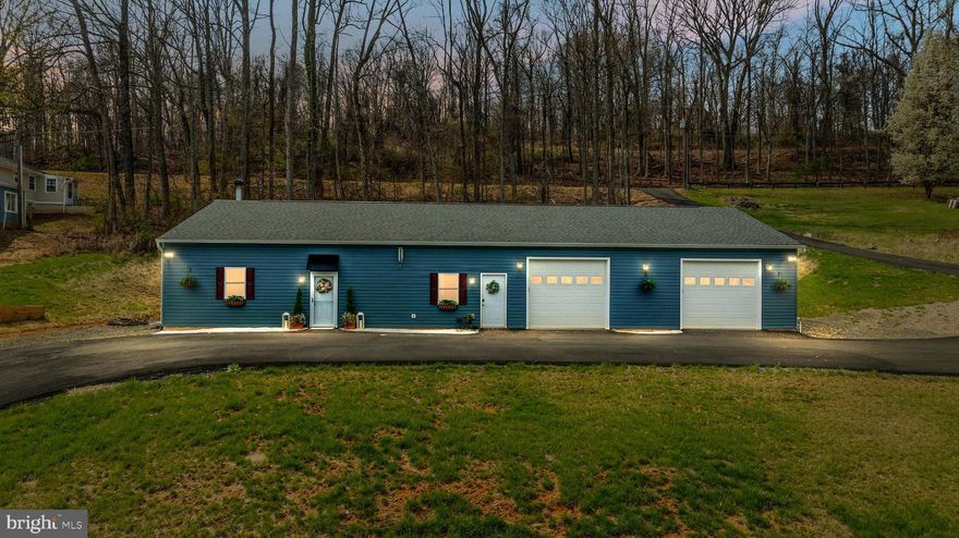 Calling all entrepreneurs, multigenerational buyers, and anyone tired of cookie-cutter homes. Built in 2023, this one-level home offers generous living space plus an oversized 3-car garage with roughly 1,100 additional square feet — a rare setup with real flexibility.  Two bedrooms sit on one side, while the opposite wing has its own exterior entrance, ideal for extended family, guests, live/work use, rental income, or a setup that grows with your needs. Need power? You’ve got it here — with TWO 200-amp panels ready to go. Inside, this home is open, airy, and truly beautiful — LVP flooring, tiled baths, stainless steel appliances, and a floor-to-ceiling stone fireplace that steals the show. The ductless mini-split system offers individualized temperature control in each room — with the added benefit of lower energy costs. Outside, the extras keep coming: paved driveway, hydrant out back for future terraced gardening, and electric conduit beneath the driveway for a future balcony deck overlooking the front yard (visit the property website for some AI-generated inspiration!). The garage is a story all its own — currently set up with a gym, but just as well suited for car enthusiasts, a workshop, studio space, storage, or a home-based business. Tucked in the countryside, yet just a hop, skip, and a jump to I-66, Route 17 and 29, and the shops and restaurants of Warrenton, The Plains, and Marshall, this is the kind of property that opens the door to possibilities. You must see it in person! Schedule a tour today.