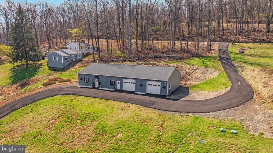 Calling all entrepreneurs, multigenerational buyers, and anyone tired of cookie-cutter homes. Built in 2023, this one-level home offers generous living space plus an oversized 3-car garage with roughly 1,100 additional square feet — a rare setup with real flexibility.  Two bedrooms sit on one side, while the opposite wing has its own exterior entrance, ideal for extended family, guests, live/work use, rental income, or a setup that grows with your needs. Need power? You’ve got it here — with TWO 200-amp panels ready to go. Inside, this home is open, airy, and truly beautiful — LVP flooring, tiled baths, stainless steel appliances, and a floor-to-ceiling stone fireplace that steals the show. The ductless mini-split system offers individualized temperature control in each room — with the added benefit of lower energy costs. Outside, the extras keep coming: paved driveway, hydrant out back for future terraced gardening, and electric conduit beneath the driveway for a future balcony deck overlooking the front yard (visit the property website for some AI-generated inspiration!). The garage is a story all its own — currently set up with a gym, but just as well suited for car enthusiasts, a workshop, studio space, storage, or a home-based business. Tucked in the countryside, yet just a hop, skip, and a jump to I-66, Route 17 and 29, and the shops and restaurants of Warrenton, The Plains, and Marshall, this is the kind of property that opens the door to possibilities. You must see it in person! Schedule a tour today.