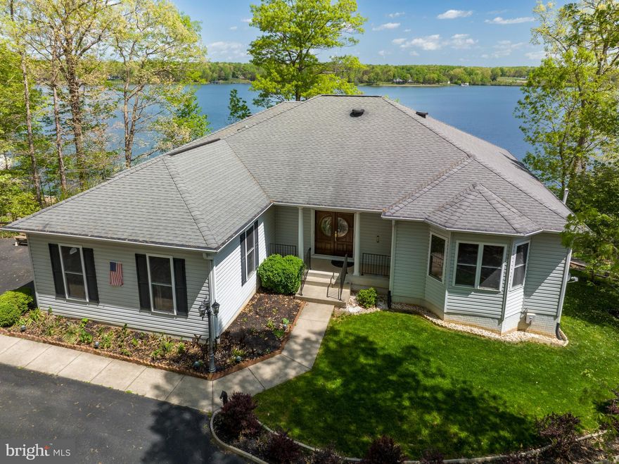 Get ready for summer fun and enjoy breathtaking views all year long! Gorgeous waterfront retreat with 258ft of water frontage, located in sought after Freshwater Estates on the public side of the lake. Featuring 4 bedrooms, 3 full baths and over 4,900+ Sqft. Many upgrades to include hardwood flooring, built in shelving, gas fireplace, tray ceilings and crown molding. The family room is open to the bright kitchen that has a center island, white cabinets, wall oven with a warming drawer and a sink overlooking the lake. Main level lakeside primary ensuite features a walk in closet, double vanities, jetted tub, separate shower and a makeup vanity. The main level also has a second bedroom that is currently being used as a home office. Full walkout basement has a large family room, rec room, two bedrooms, a full bath and lots of storage. Whether you are on the full length double decks or down at the boathouse, you will love entertaining your family and friends here. There is a paved driveway down to the boathouse where you'll enjoy deep water (12 ft at end of dock), with 1 electric boat lift, 1 electric jet ski lift, a sundeck, screened area, a second level for tanning, storage area and there is even a de-icer at the boathouse. Two car attached garage and paved driveway. Shed and generator convey! Great lake location on the popular Contrary Creek. At this retreat, you'll also enjoy its incredibly convenient location, roughly 45 minutes from Richmond, 90 minutes from DC, less than 5 miles from the town of Mineral, roughly 6 miles from the New Bridge Landing Shopping Center, where you'll find groceries, restaurants, ABC, a nail salon, vet clinic, and more. Schedule your tour today! See list of updates in MLS documents.