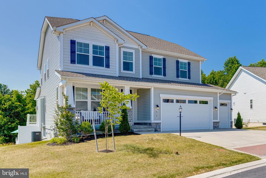 Welcome to this absolutely incredible, built in 2019,  5 bedroom, 3.5 bath house on what I believe is one of the best lots in Bulle Rock!  This home sits in the back of the community with an open space next door and backs to woods, and a pond.  Enjoy the many amenities that the Bulle Rock community has to offer including community pool, restaurant, golf, lounge, etc.  This house has a three car garage and a large driveway.  Park and make your way up to the large covered front porch.  Entering brings you to a main level covered in luxury vinyl plank flooring with an office to the left and a hallway with a main floor powder room that opens up into a completely open floor plan with a living room with gas fireplace to the left and a massive gourmet kitchen to the right.  This chefs kitchen comes with a massive granite island, granite countertops, backsplash, all stainless appliances including wall ovens, and a walk in pantry.  The kitchen overlooks a dining area which sits in a brightly lit sunroom area overlooking the rear woods and yard beyond.  A door off of this area takes you to a covered rear deck with ceiling fans that has steps down to the large rear paver courtyard below.  Inside of the walled courtyard is a grilling area, built in fire pit and hot tub, along with tons of room for relaxing and entertaining.   Taking the stairs up to the second floor brings you to a second open area living room, along with a laundry room with cabinetry and lvp flooring for easy access, a full bath with tub/shower combo, two bedrooms, including a third that's been converted into a walk in closet and a large owners suite.  The owners suite has tray ceilings, a large modern full bath with soaking tub, stand up shower, and double vanity, and a walk in closet (the sellers took a wall down to join the walk in closet to the fourth bedroom to make it a massive walk in closet.  This can easily be converted back to make a 5 bedroom house).
The finished basement has another full bath and bedroom with walk in closet, as well as a living area, and a large room that has been framed out and could easily be finished, as well as a large storage room with mechanicals including the tankless hot water heater for unlimited hot water.  Doors off of the finished basement lead out into the large rear courtyard.  This home is a dream, is modern and basically all new.  It is move in ready and waiting for you!