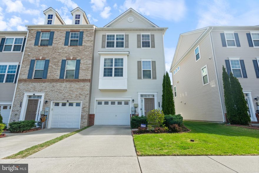 Welcome to 9513 John Locke Way! This well maintained end of group townhome in popular Ballard Green, built in 2016, features a bedroom/office/family room with two spacious closets and a full bath on the entry level, where you can walk out to the fenced rear yard. On the main level, you'll find an open concept living/dining room with a powder room and chef's kitchen, all with hardwood floors. A maintenance free deck is accessible on this level for warm weather fun.  On the upper level is a luxurious primary bedroom retreat with a walk in closet and a spa bath. Two nicely sized bedrooms, a large hall bath and an upper level laundry complete the top floor.  The home also features a smart thermostat for energy efficiency and a one car garage. Lawn care for unfenced areas is included in the HOA fee, as are all the amenities of Ballard Green, including a pool, fitness center and two playgrounds.  Move in, unpack and enjoy the ease of living in this lovely home!