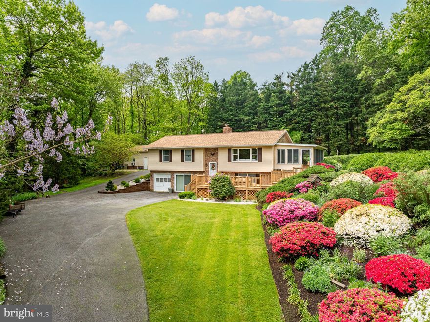 Now available in Street, MD, is this truly breathtaking property situated on 6.95 acres of park-like beauty. This home features stunning landscaping, a three-season room, two garages, and a fully stocked spring-fed pond in the front yard. Two years ago, a new architectural roof was installed on the main house and the detached garage. Gutter guards were installed on the house and garage as well. The recently remodeled kitchen features quartz countertops, 36-inch cabinets, stainless steel appliances, a gas range, a kitchen island, and plenty of table space. The kitchen dining room combination is perfect for entertaining. Hardwood floors are throughout the main level. Leading from the kitchen is a beautiful three-season sunroom built with Anderson Windows that can be used as an entrance or exit to the front of the home. The primary bedroom on the main level has an attached full bathroom that has been remodeled. Two additional bedrooms and a remodeled full hall bathroom are on the main level. The lower level of the home includes a wood-burning stove, a half bathroom, a large den area, a laundry room, and an entrance to the attached garage. Park your cars in the attached garage space or the 36x24 detached garage with plenty of storage space. The detached garage is heated and has 100 AMP electrical service, and the shed on the driveway also has electricity. Large Trex deck on the front of the home. The landscaping and horticulture on the property is magnificent. Apple trees, pear trees, and many more varieties of plants and trees adorn the property. The spring-fed pond in the front yard is fully stocked with Bass, Bluegills, Catfish, Crappie fish, and more. Schedule your tour in advance to see this one-of-a-kind home!