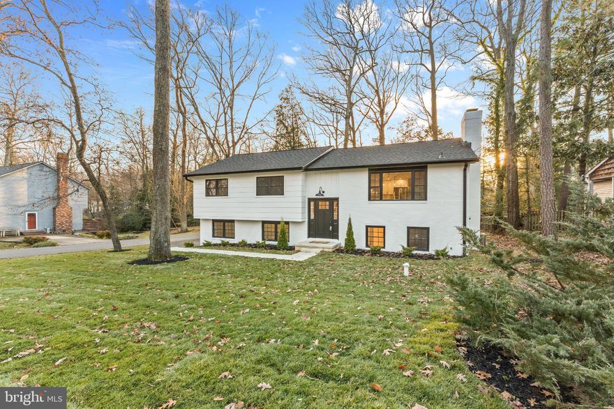 Discover an exquisite blend of luxury and comfort in this stunning split foyer home, nestled in the prestigious Annapolis Roads community. This meticulously maintained residence, a major renovation in 2025, boasts an impressive 4 bedrooms and 3 full baths, offering ample space for relaxation and entertainment. Step inside to find an open floor plan that seamlessly connects the gourmet kitchen, back splash and under cabinet lighting and featuring upgraded countertops and a spacious island, to the inviting living and dining areas. Elegant wood floors and recessed lighting enhance the ambiance, while a cozy wood-burning fireplace adds warmth to the heart of the home. The entry-level bedroom provides convenience, and the fully finished basement with garage access offers endless possibilities. Outside, enjoy the serenity of a corner lot surrounded by lush trees and woods, creating a private oasis. The screened patio invites you to unwind while overlooking the beautifully landscaped yard. With access to Lake Ogleton just blocks away, indulge in a lifestyle of water activities, including kayaking and electric boating from your own private dock. This property is not just a home; it's a lifestyle. With energy-efficient windows and a comprehensive water treatment system, every detail has been thoughtfully considered. Experience the perfect blend of luxury living and nature's tranquility in this exceptional residence. Don't miss your chance to call this remarkable property your own!  Minutes to Shopping, Restaurants and USNA.