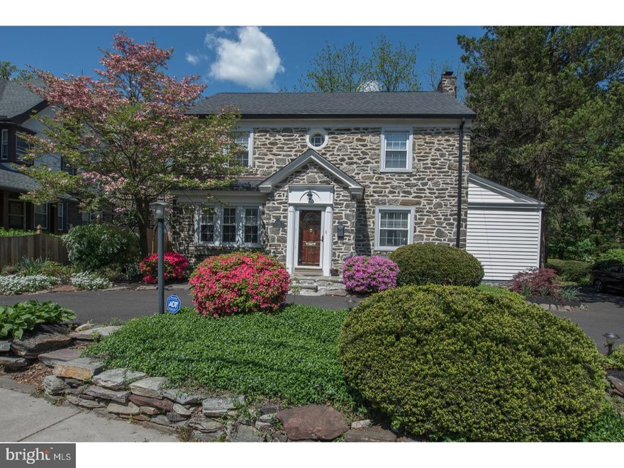 Gracious Stone Colonial set back with mature plantings, a gardeners paradise! This center hall has been beautifully updated. You will enjoy the fine details of the large sun filled living room with wood burning fireplace, built in niche and large walk in storage room. Spacious dining room with large front facing window is great for Holiday Dinners and entertaining. This kitchen will delight any cook! Lots of great wood cabinets for storage, plenty of counter space, recessed lighting, stainless appliances offer a great place to cook and not miss out on the fun. Extended counter space makes a great place to pull up a chair or use the space for serving food. Kitchen opens to the highlight of the house! An enormous family room with bright bay window allows you to enjoy the beaucolic  setting. Step outside into a gardeners paradise! Relax on your deck with outside speakers, perrienal plantings and fruit trees, fenced yard. You will enjoy the park like setting, just in time for those summer BBQ's! Second floor features a beautiful Master Bedroom with recently renovated en suite. Large walk in shower with custom glass doors, European inspired cabinetry and beautiful tile. Plenty of closet space. Additional two bedrooms with spacious closets. Beautiful hall bath, partially renovated with bathtub. Don't miss the pull down attic space that was converted into another space currently used as a guest bedroom/office. This overlooks the beautiful rear yard. Full finished basement and powder room, mechanical/storage area and laundry room. This home has been lovingly maintained and upgraded throughout. New Hardwood floors on the first floor, newer windows,Heating/AC 2016, Roof Replaced 2013/2015 on addition, new fence 2017. Conveniently located walking distance to Melrose Park Station with easy access to Center City/Airport. A quick commute to area Universities and Hospitals, 309,476 and Turnpike. Buy with confidence, 1 Year Home Warranty.