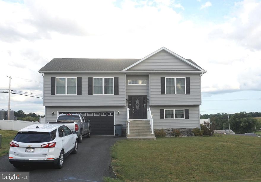 3 BEDROOM/3 FULL BATH Split Foyer in the Butlers Bridge Community- Excellent condition- Built in 2020. Cathedral Ceiling Great room, White shaker kitchen w/ granite top, center island, stainless steel appliances, tile backsplash & under cabinet lighting. luxury vinyl plank flooring, Master suite with tray ceiling & ensuite bath with tile shower. Over sized rec room in lower with luxury vinyl plank, 3 full bath in lower level, All baths come with granite topped vanities. Sellers have installed luxury vinyl plank in the oversized garage & installed a mini split heating & air unit to condition the space. Back yard Oasis is complete with a large Trex deck with stairs to the lower level, firepit, shed, lower level paver patio & 6' white vinyl privacy fence- Home is located on a corner lot and has amazing side views of the farm market and North mountain- Hedgesville School District- Convenient location close to 81 & shopping!