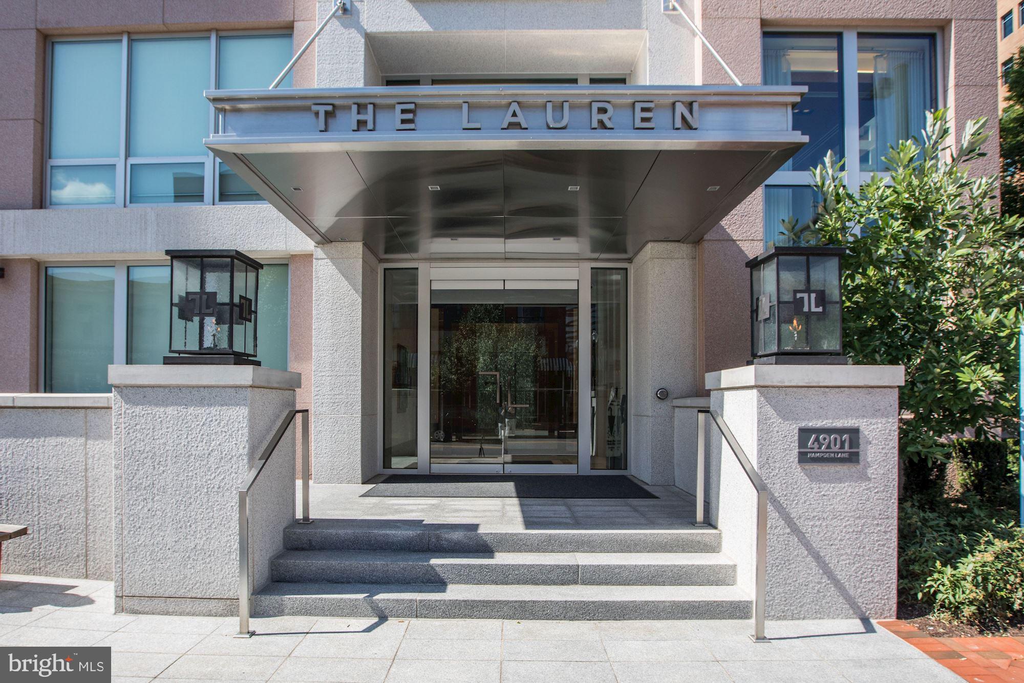 NEW LISTING!! Welcome to The Lauren, downtown Bethesda's most sought-after address. This luxury building, finished in 2015, is replete with amenities including a 24-hour front desk/concierge, secure access, separate climate-controlled wine storage, an expansive roof deck and an elegant party room, just to name a few. Unit 405 is a beautiful two-bedroom, two-bathroom home. The updated kitchen features marble countertops and clean white cabinetry, as well as high-end stainless steel appliances. The open plan living area, spacious enough for a designated dining area, boasts custom built-ins and an impressive marble fireplace. This area also allows for access to the private outdoor terrace, perfect for alfresco dining and entertaining. The spacious primary suite includes a walk-in closet and huge bathroom with soaking tub and television artfully located in the vanity's mirror. The unit also includes a generously proportioned secondary bedroom, with adjacent full bath, as well as a full-size laundry room, with plenty of shelving for storage. The unit also comes with two designated parking spaces in the secure underground parking garage and two storage units, one of which is a large storage room - a unique feature not common in the building. The building's prime location allows for convenience and is walking distance to all the shops and restaurants at Bethesda Row. Live graciously in this rarely available luxurious home – comfort and convenience, as well as style, that can't be topped!