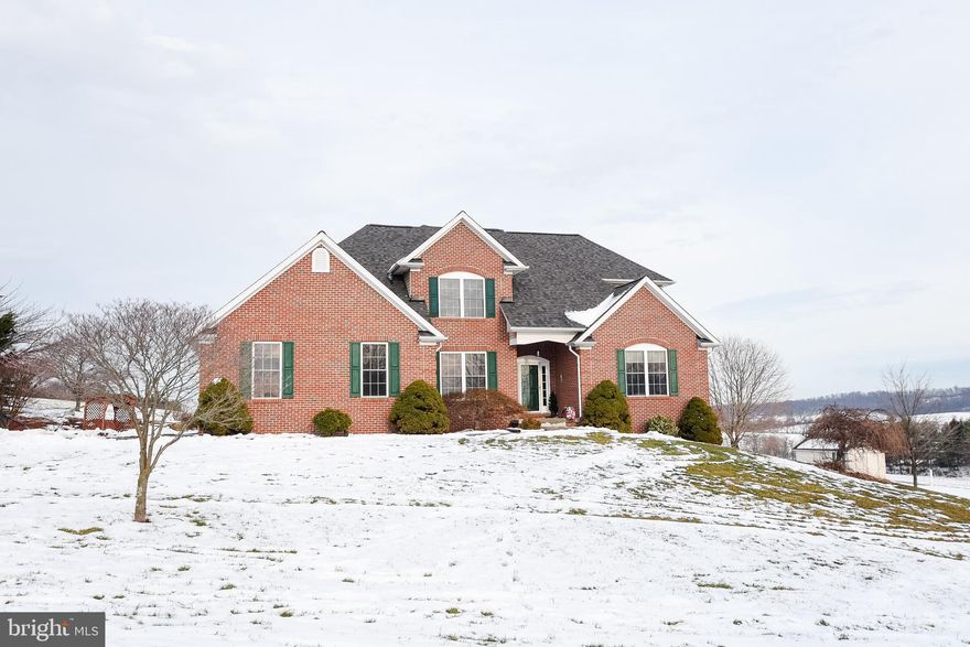 PROFESSIONAL PHOTOS COMING ON TUESDAY  1-23. Nestled on just over 4 acres , this 4-bedroom colonial is a haven of elegance and serenity. Once inside you are greeted by an open floor plan adorned with beautiful hardwood floors and an abundance of windows, inviting the natural beauty of the outdoors in.  The open floor plan seamlessly connects living spaces, making it an entertainer's dream.   Modern appliances and ample counter space make the kitchen space both functional and beautiful.  The primary bedroom on the main level offers a luxurious retreat with a full bath, ensuring convenience and privacy. The second bedroom is a delight with its own full bath, while bedrooms 3 and 4 share a cleverly designed buddy bath.  The finished lower level opens doors to endless possibilities, providing an ideal space for an in-law suite or a versatile entertainment area, expanding the charm of this already extraordinary home.